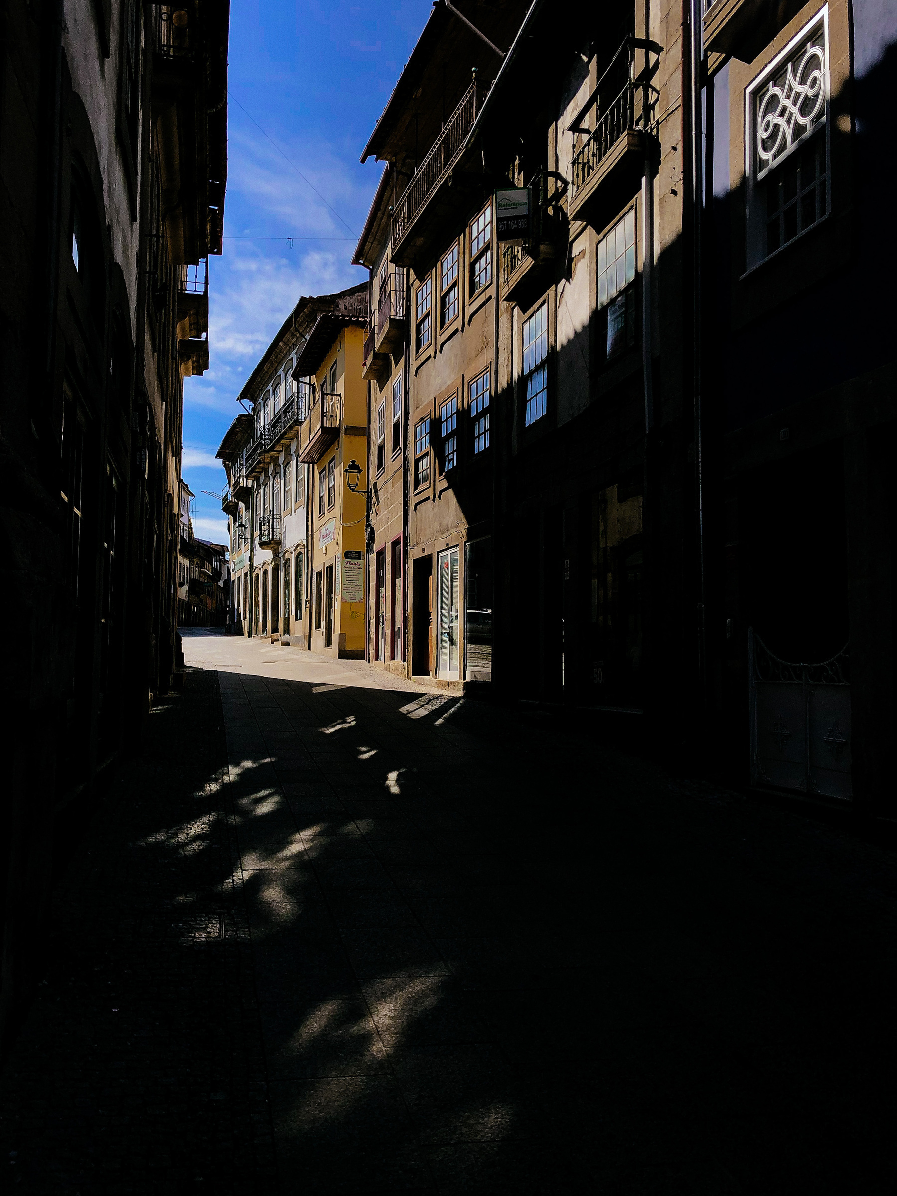 The city center, with old buildings. Dark street. 