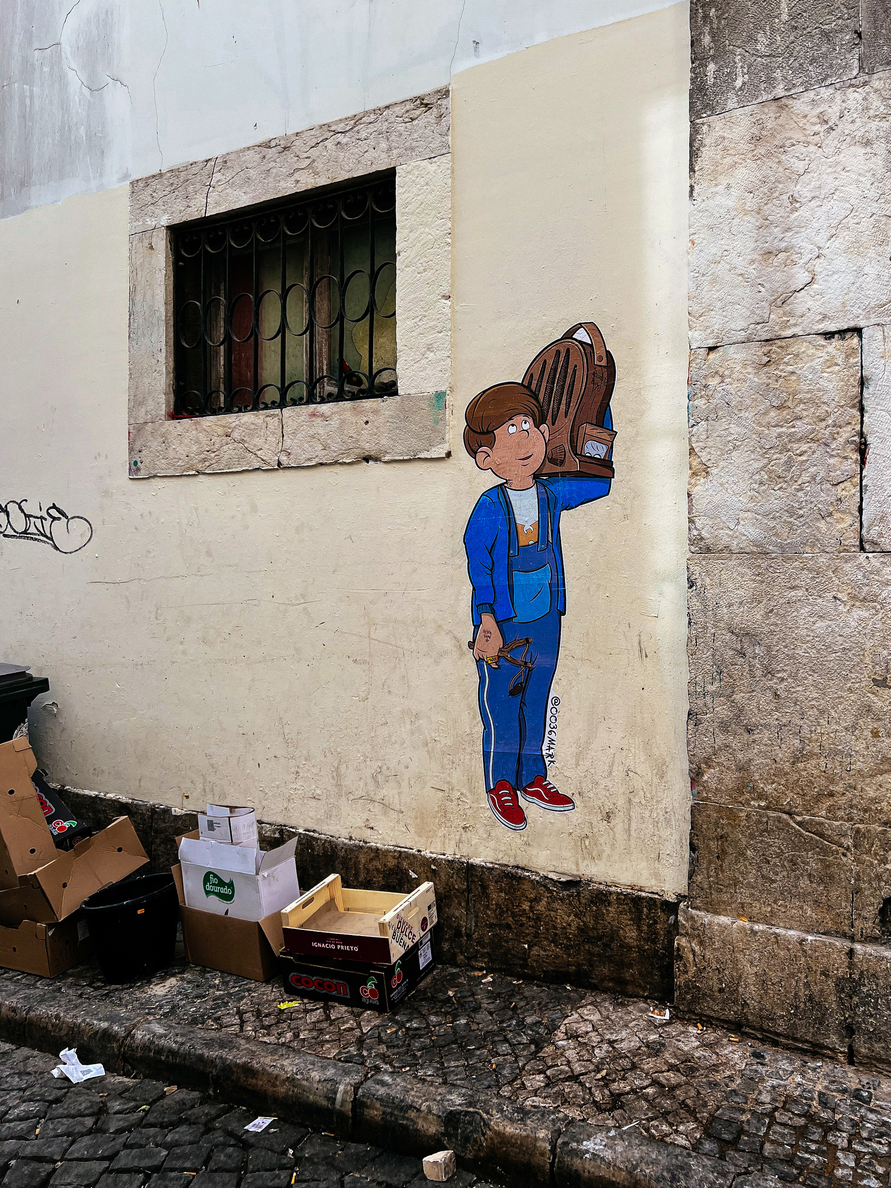 street art on a corner, a boy holding a backpack