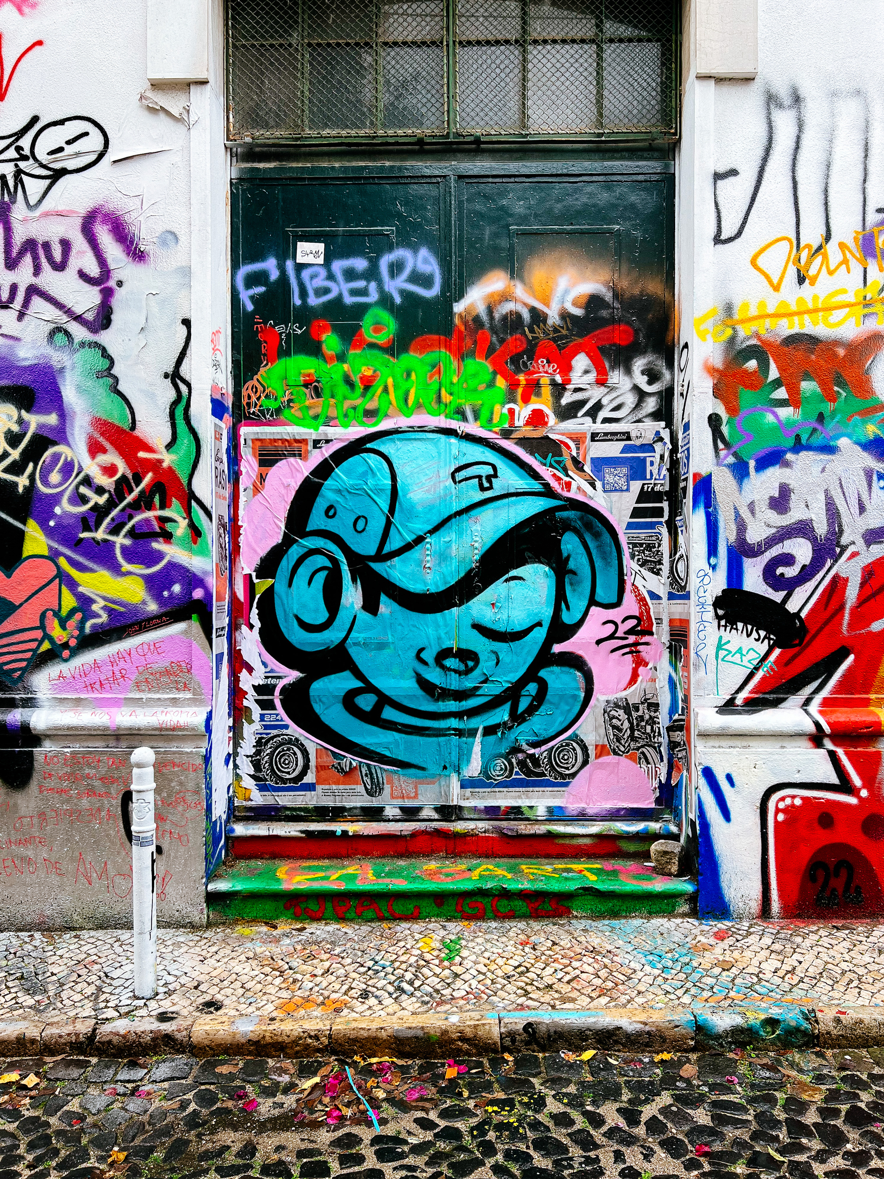 Graffiti, a blue faced boy with a cap on. 