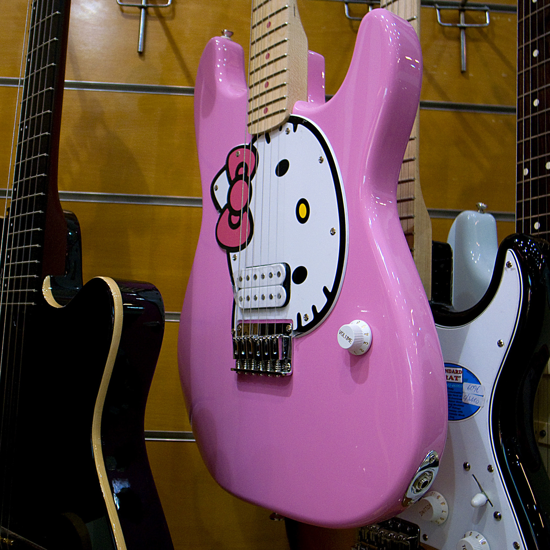 a pink guitar with Hello Kitty on it