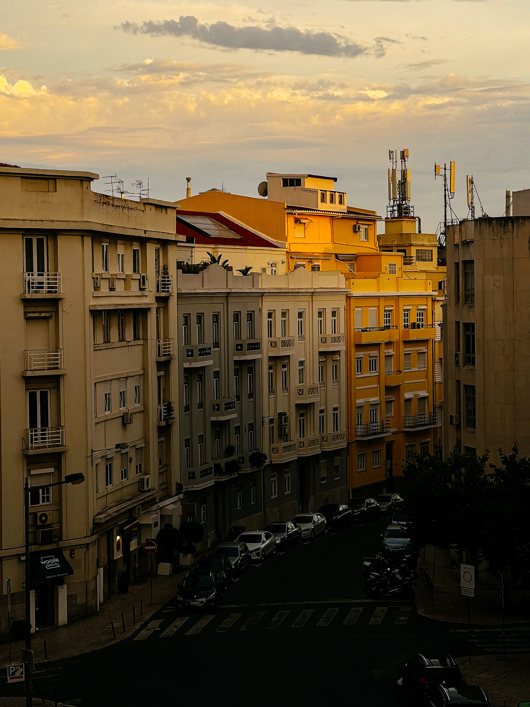 A street view with buildings painted in different shades of yellow. Sky also yellow. 