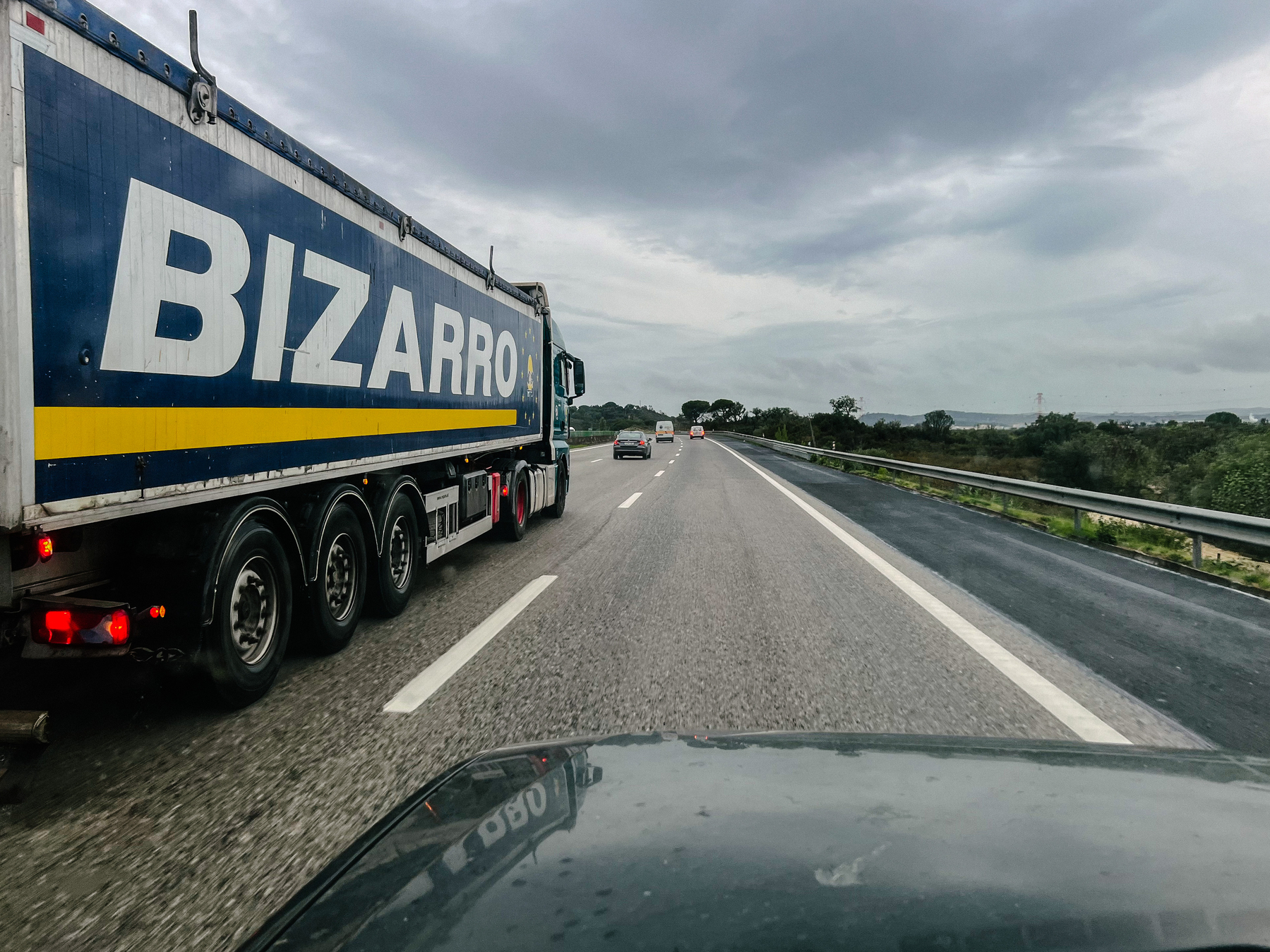 A huge truck on the highway, “Bizarro” written on the side 