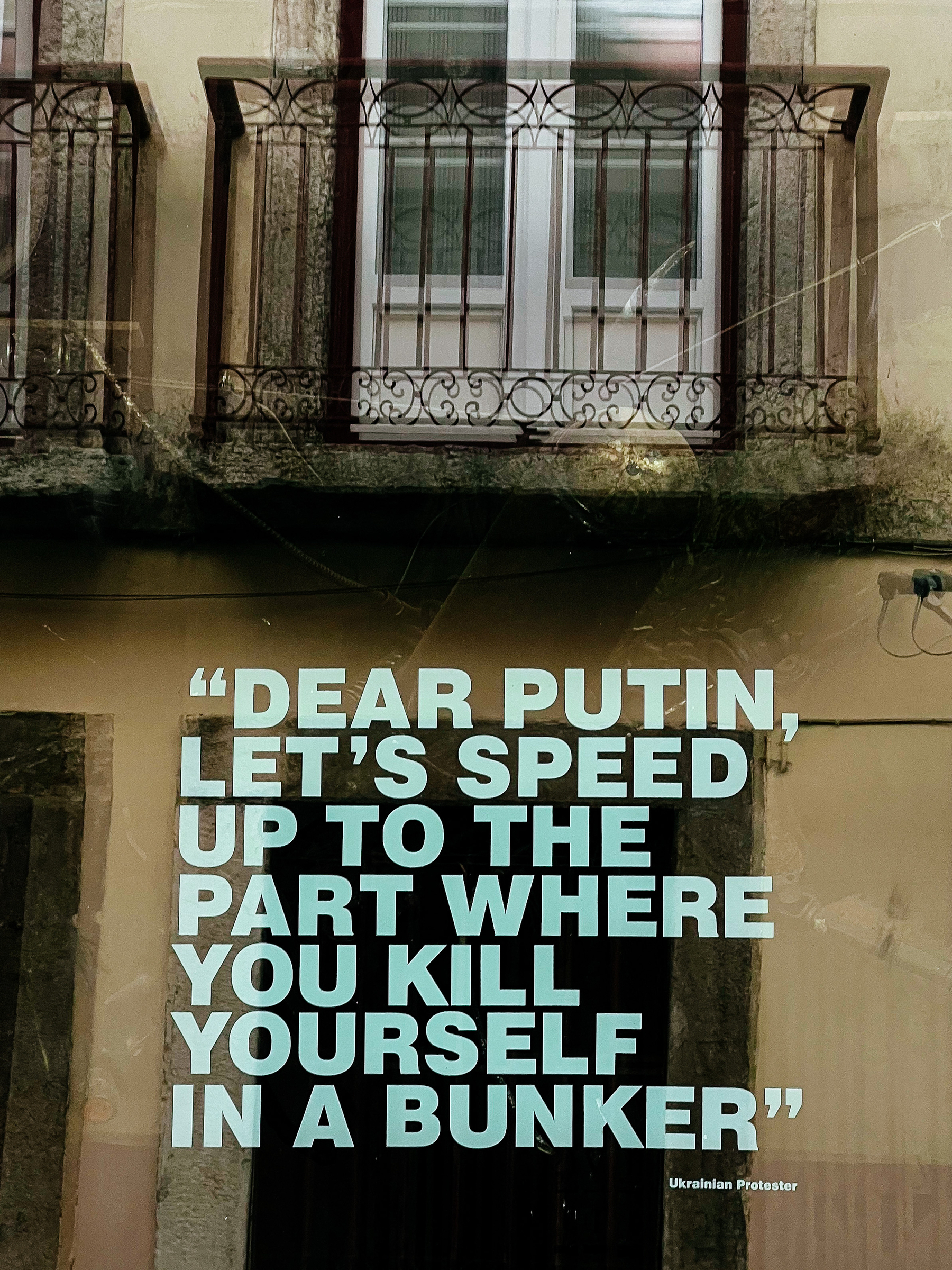 Sticker on a window, with the text “DEAR PUTIN, LET’S SPEED UP TO THE PART WHERE YOU KILL YOURSELF IN A BUNKER”