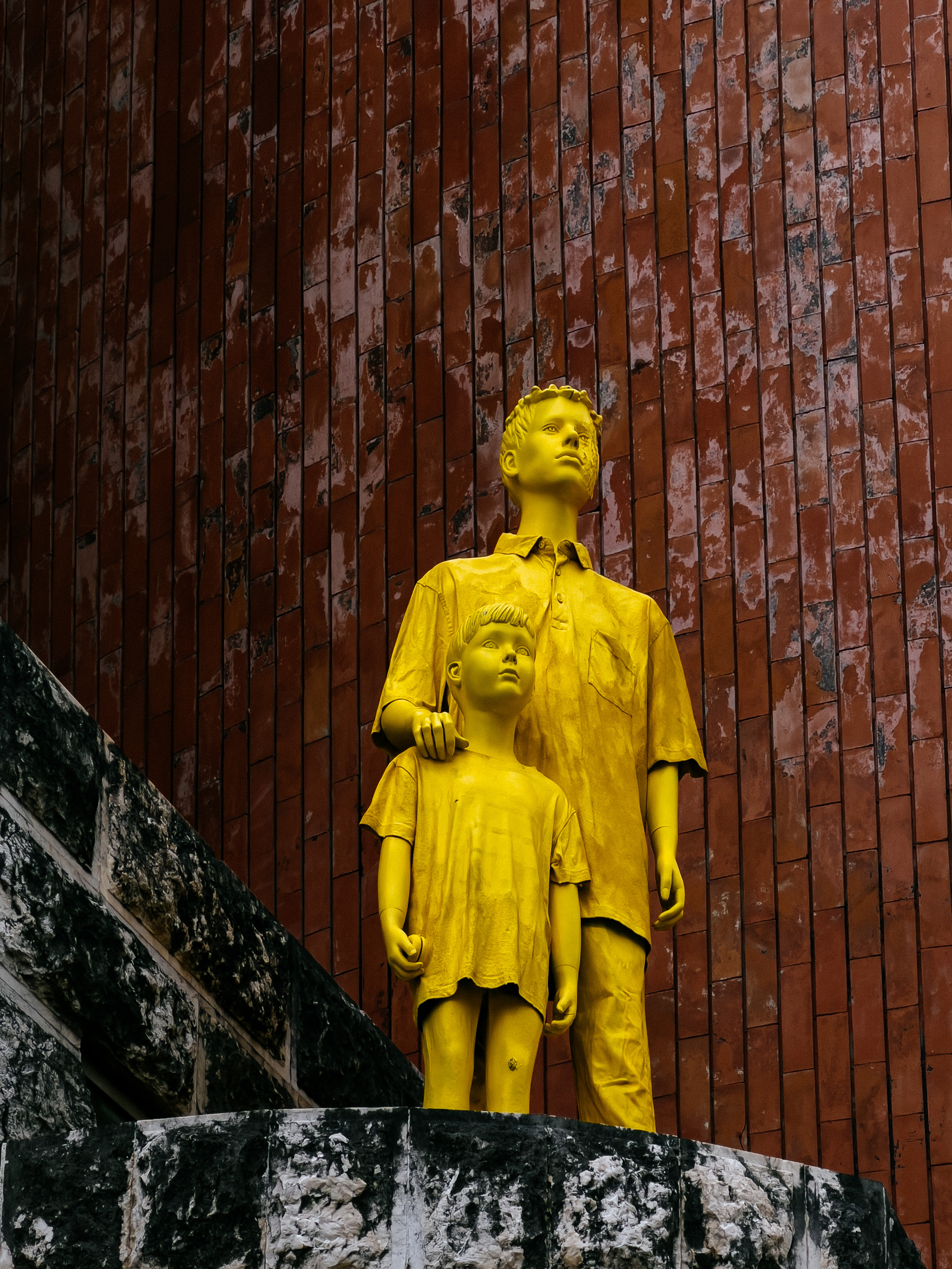 A street art piece, two boys in yellow 