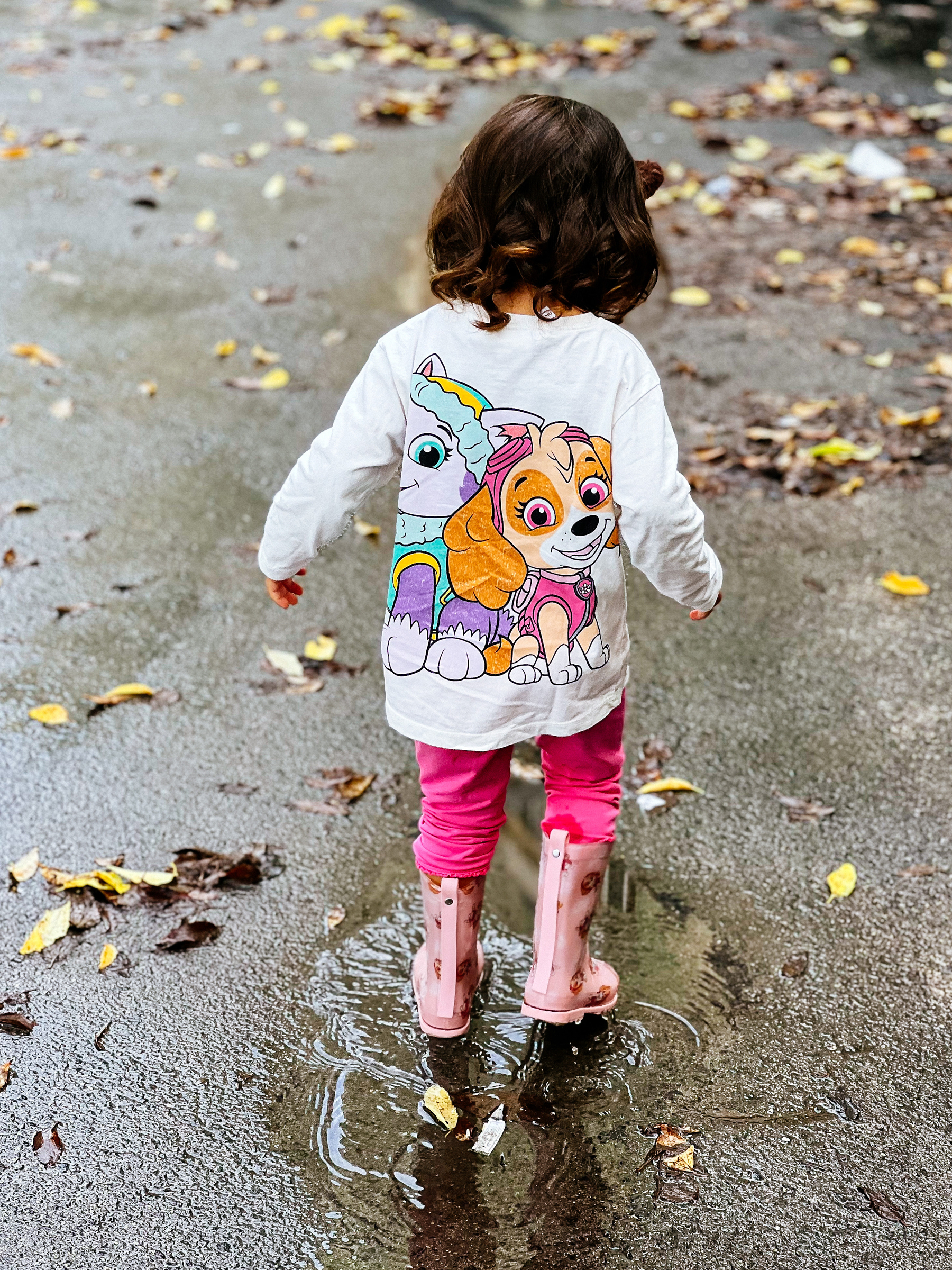toddler jumping on puddles