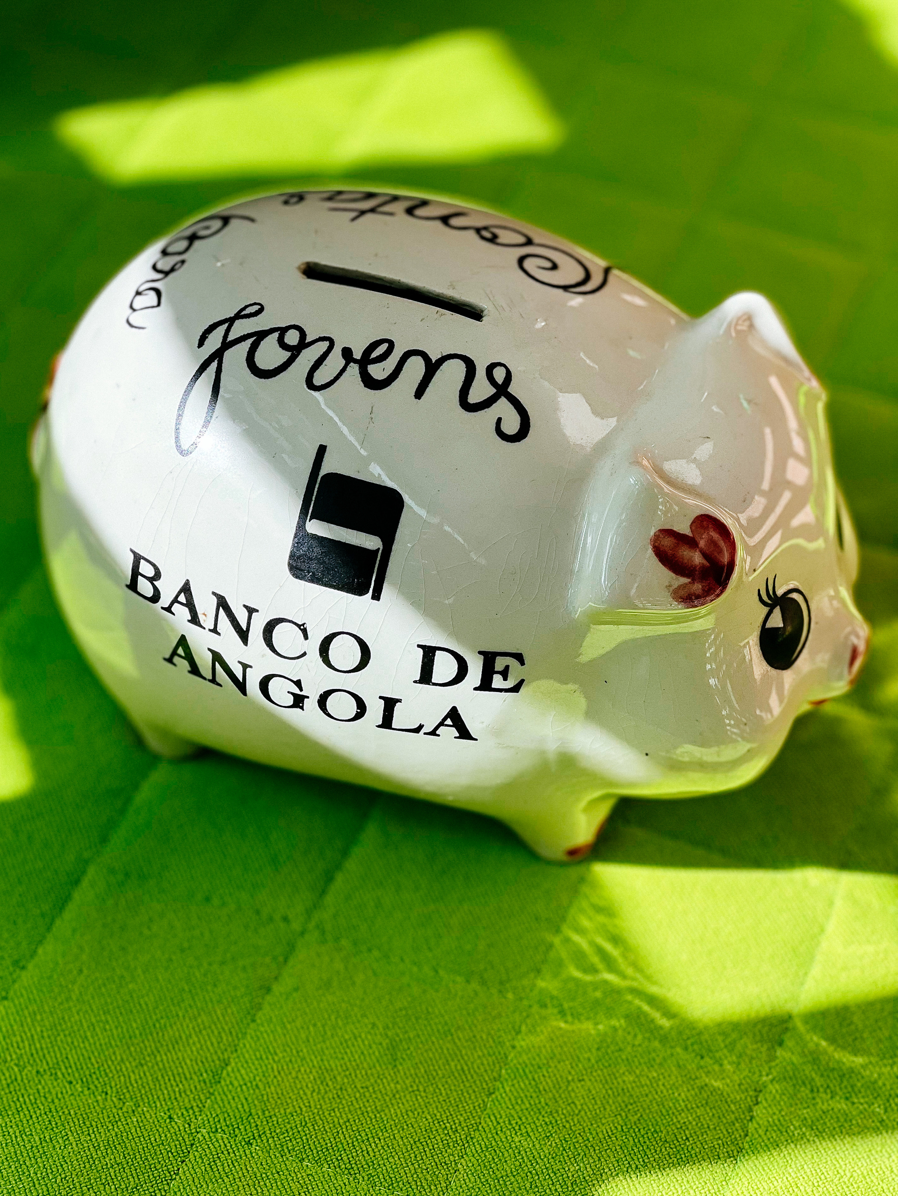 a piggy bank with “Banco de Angola” written on the side