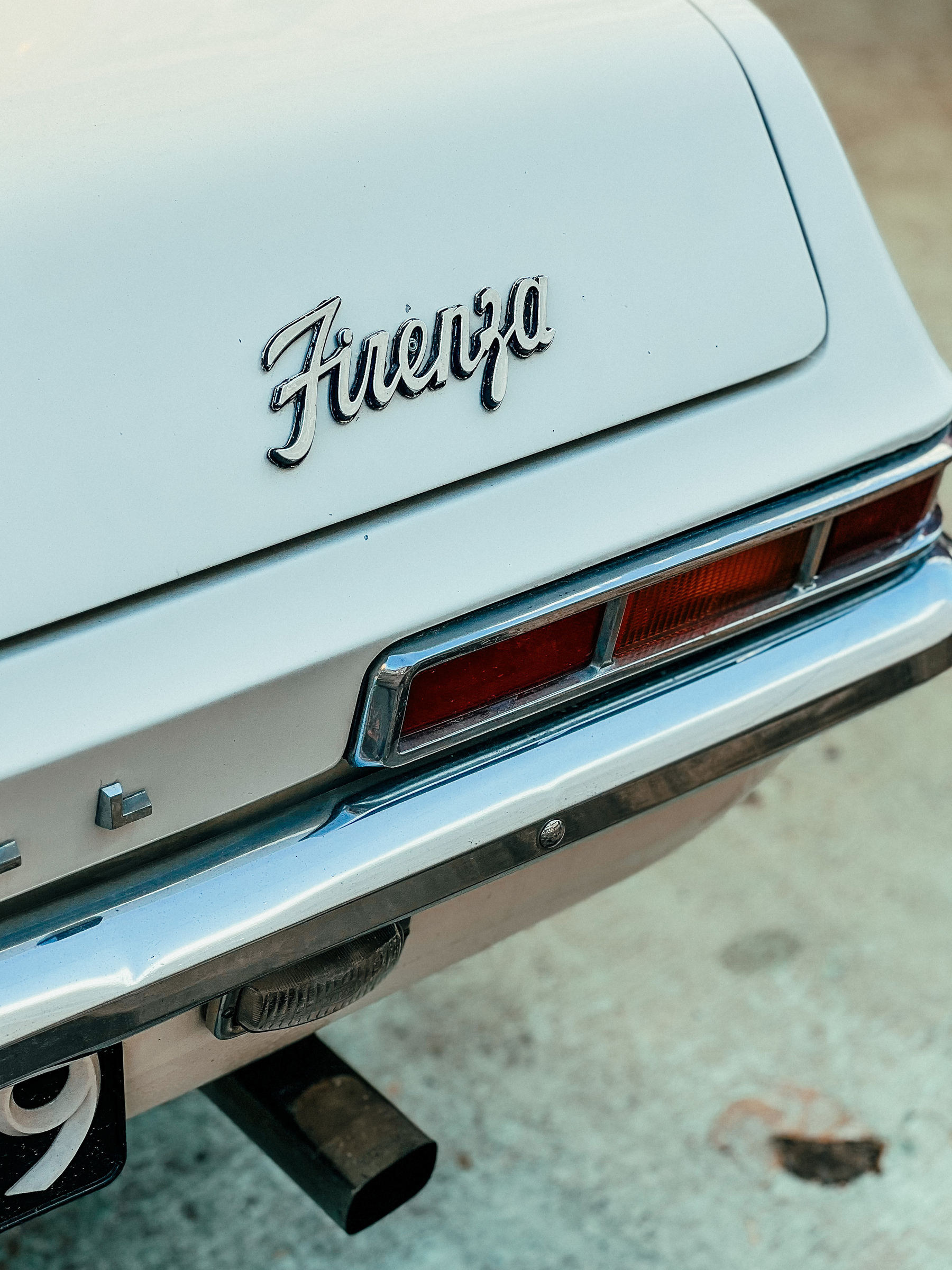 Detail of the back of a car, the word “Firenza” is visible.