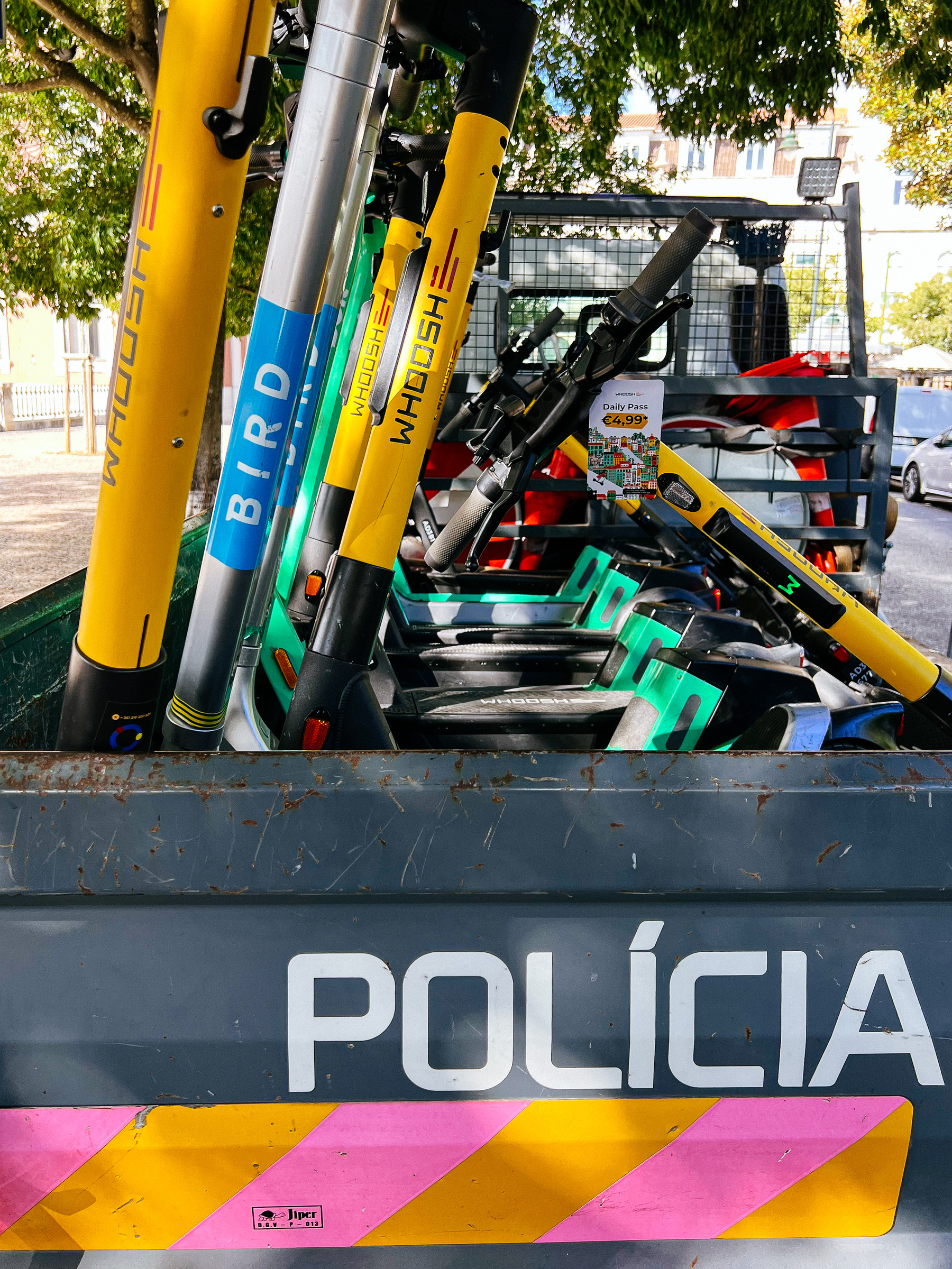 scooters being carried away on a police truck