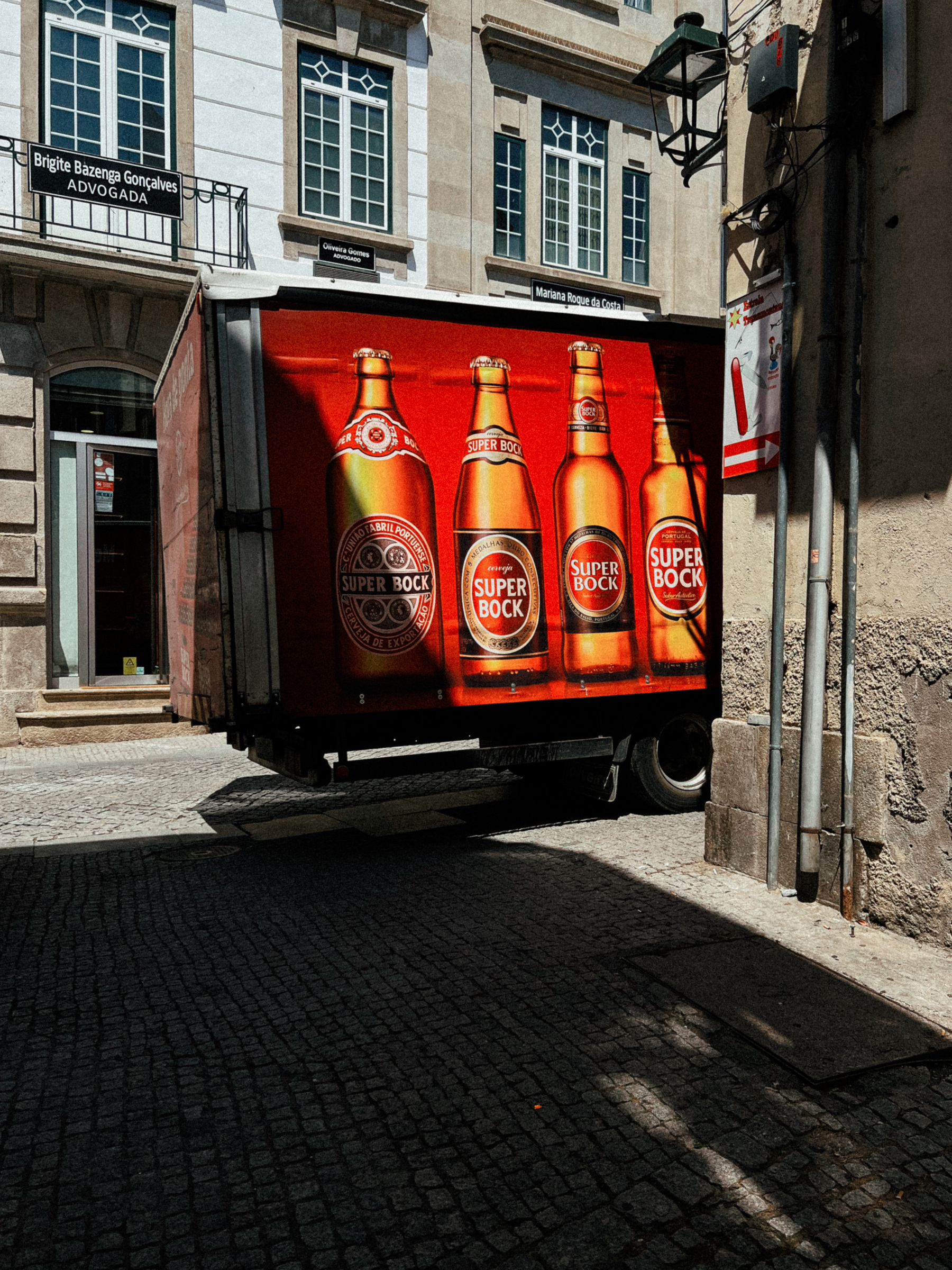 A beer truck parked in the old part of town 