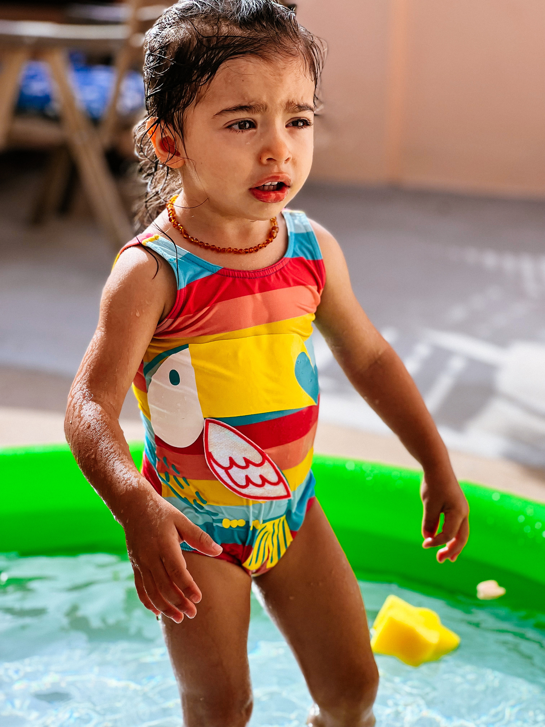 Toddler in inflatable pool. 
