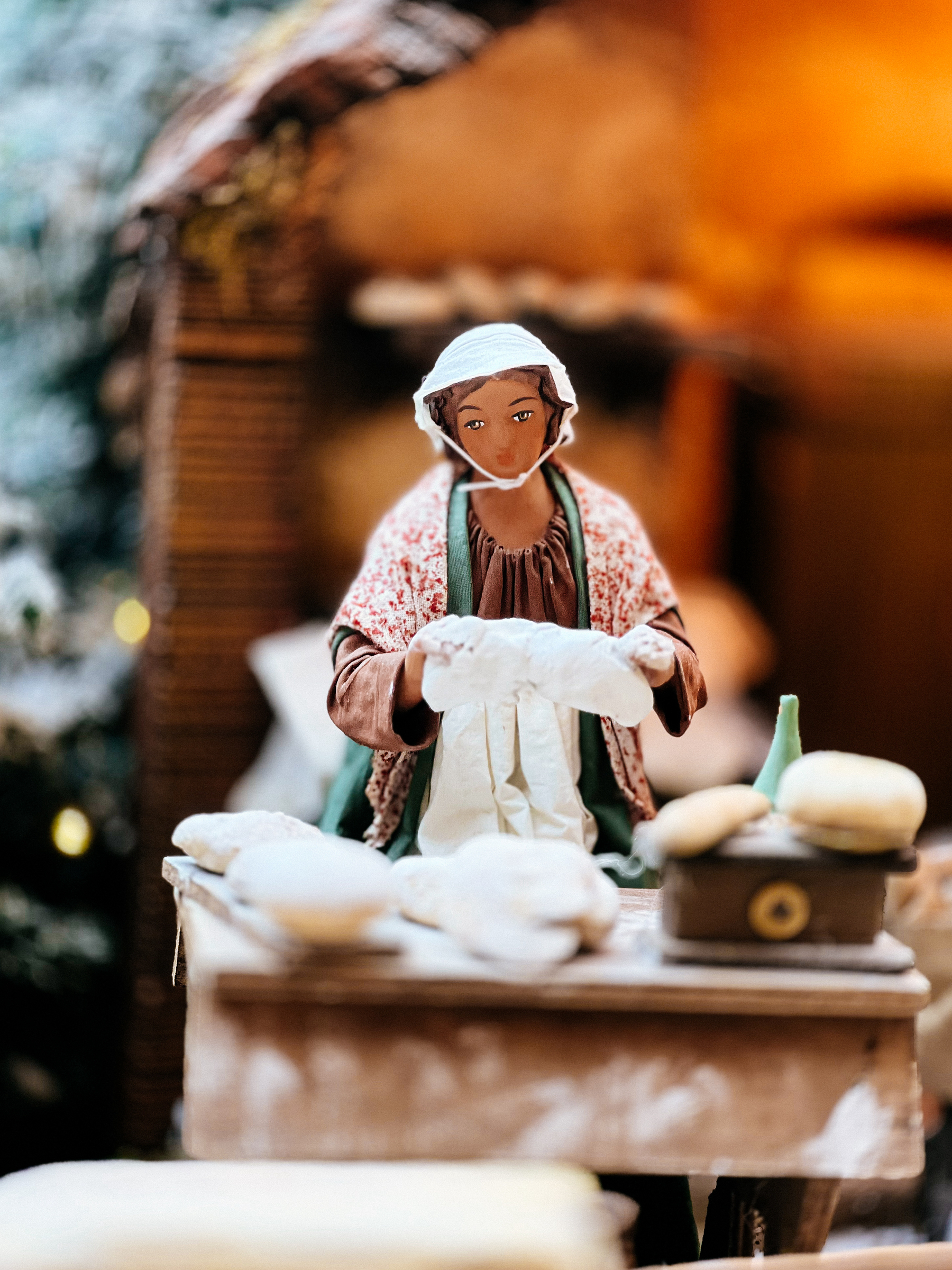 A character in a nativity scene. A woman baking bread. 