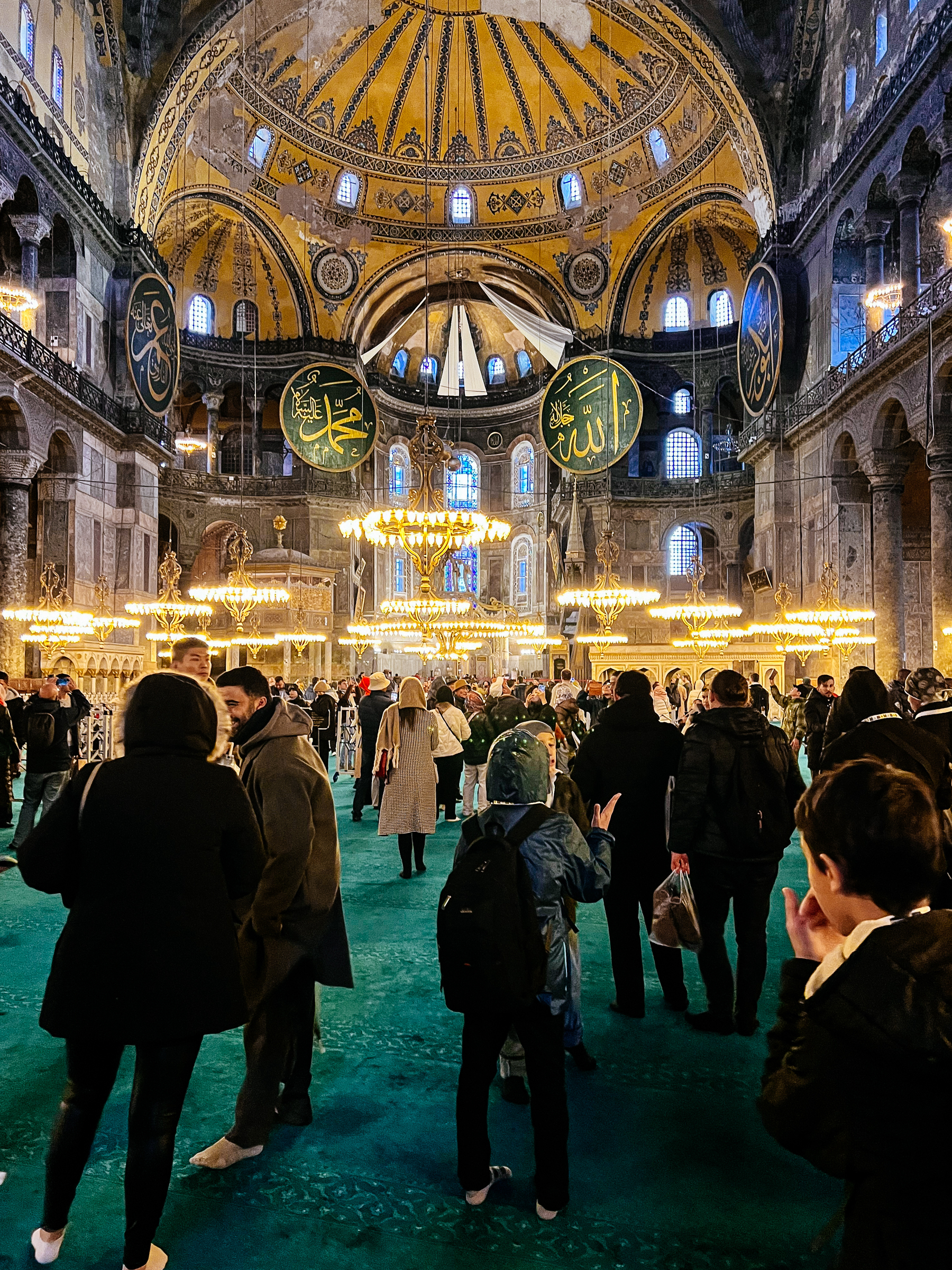 People stand inside Hagia Sophia, a beautiful mosque. 
