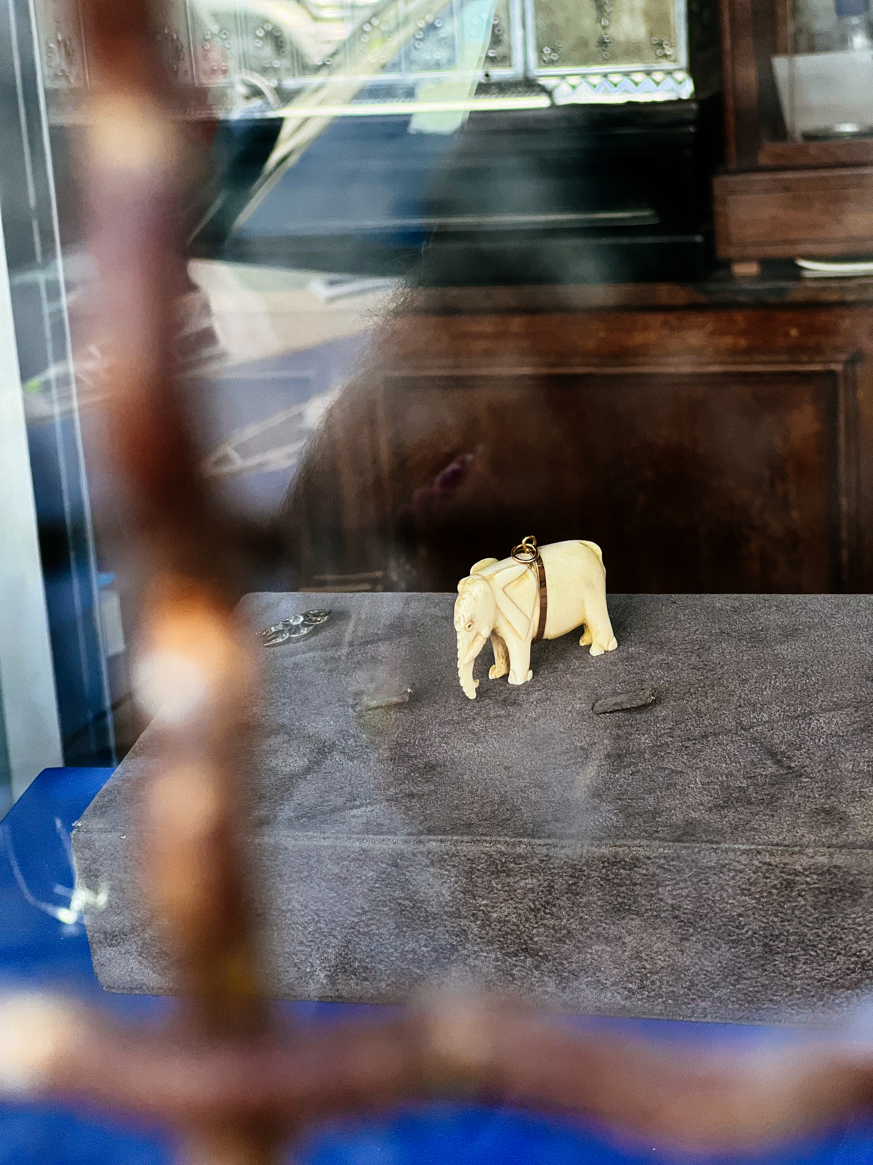 A tiny elephant (plastic?) on an abandoned shop window. Poor thing. 