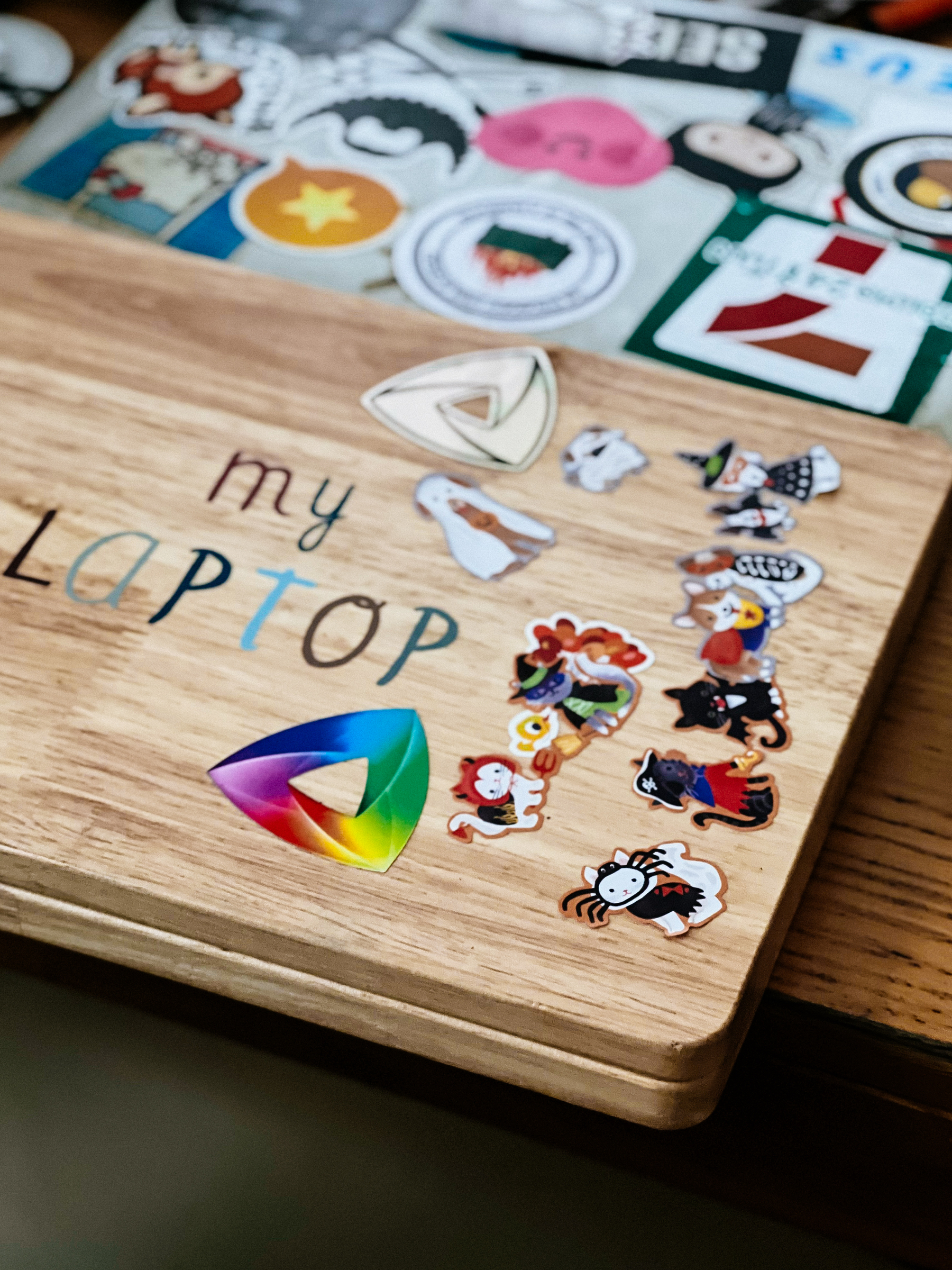 A wooden laptop, a toy, with loads of stickers, just like dad&rsquo;s (seen in the background).