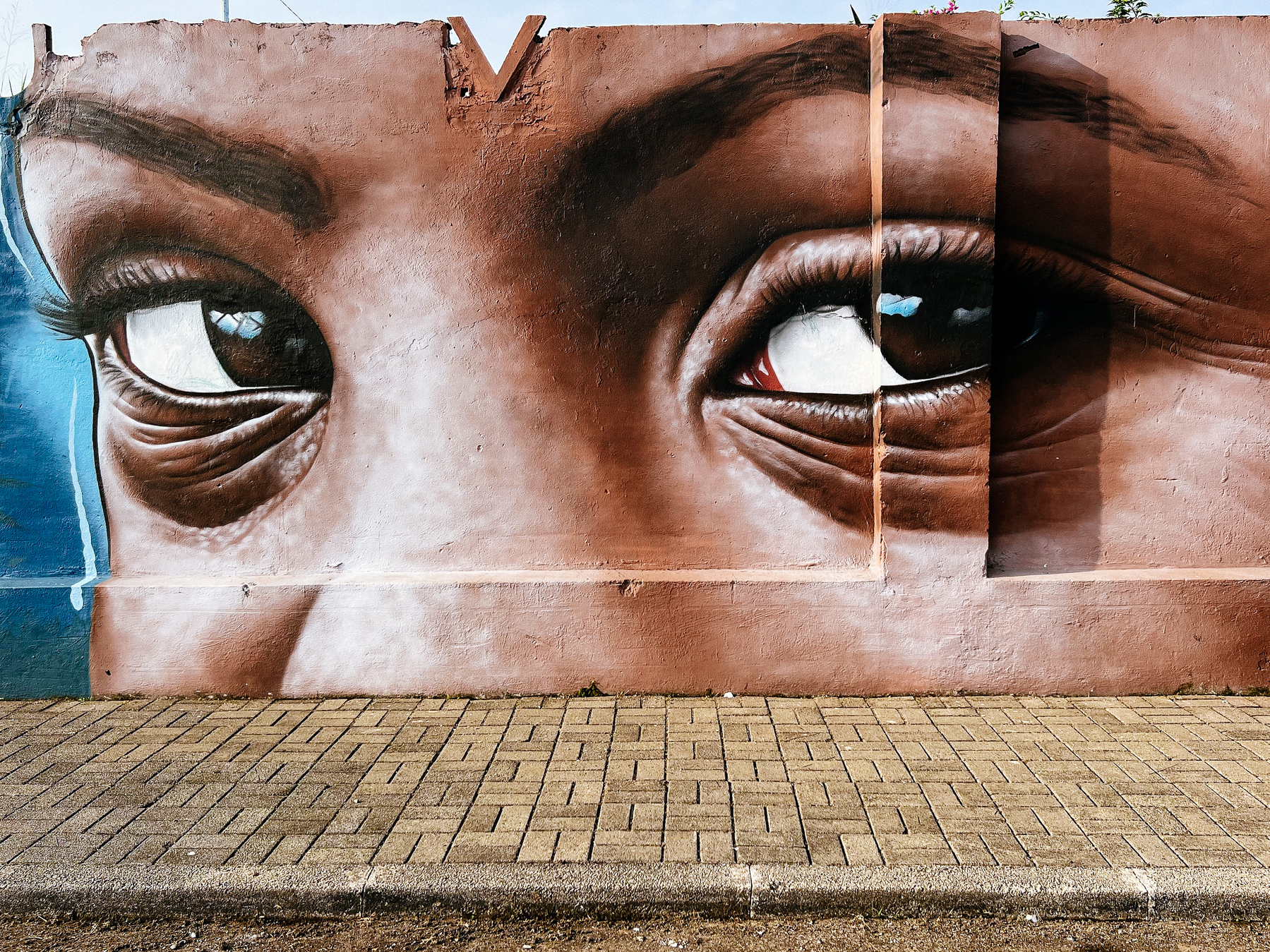 A street art piece, realistic eyes looking at us. MRDHEO is the artist. 