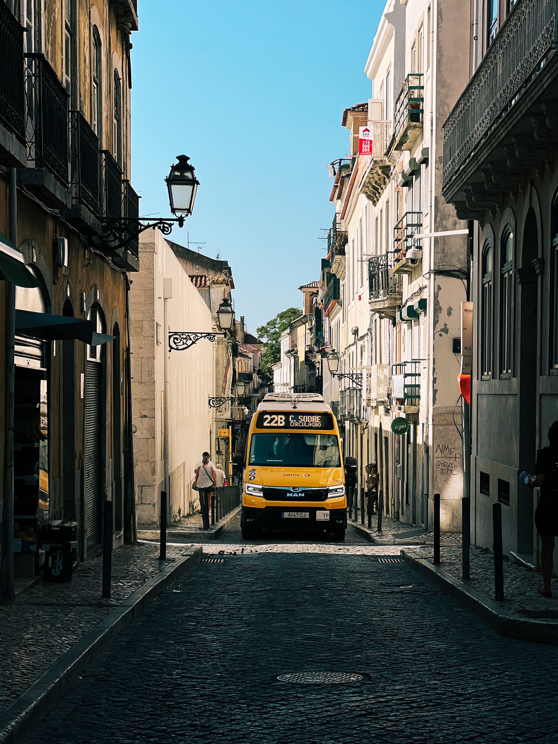 A tiny bus on the narrows streets of downtown Lisbon. 