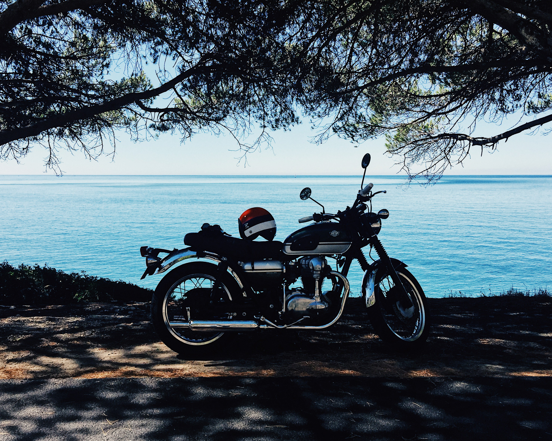 a motorcycle parked by the sea.