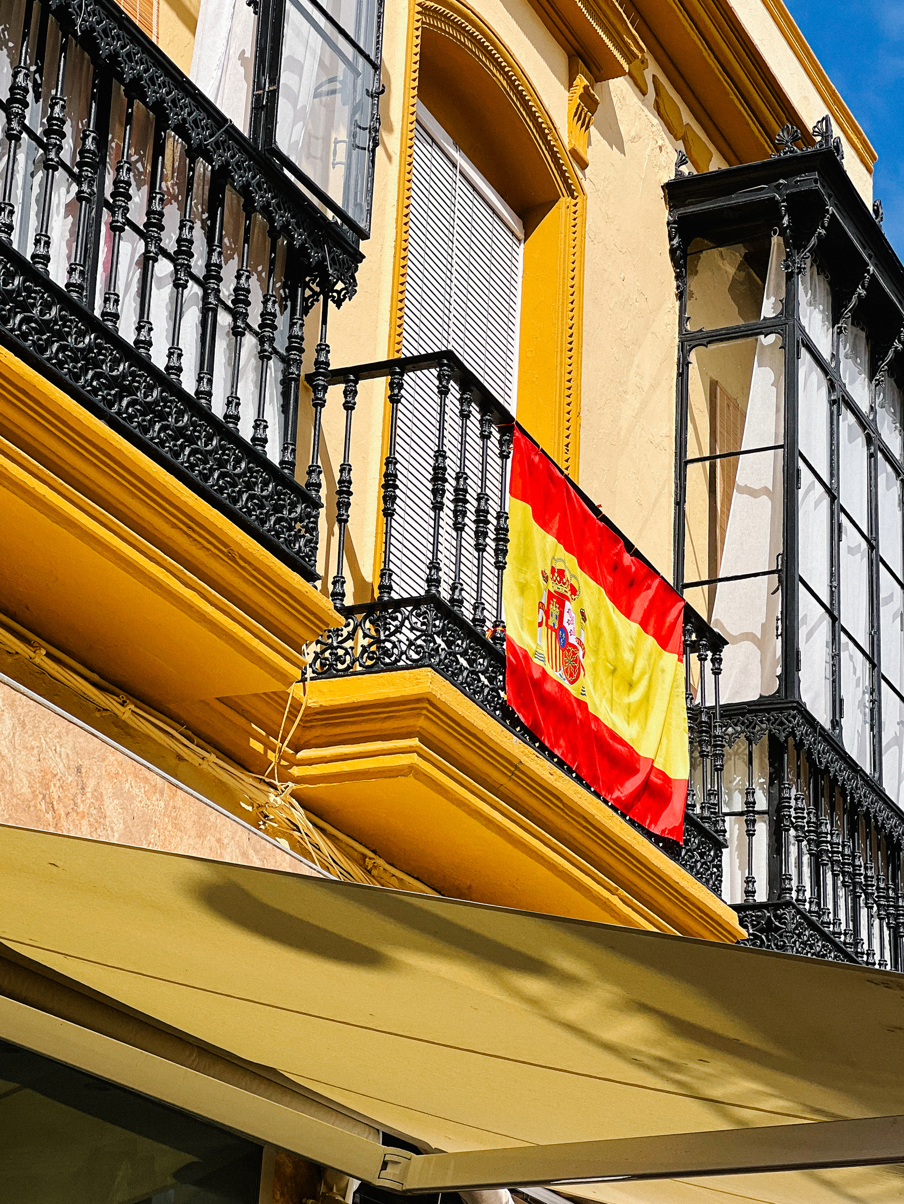 A Spanish flag on a window. 
