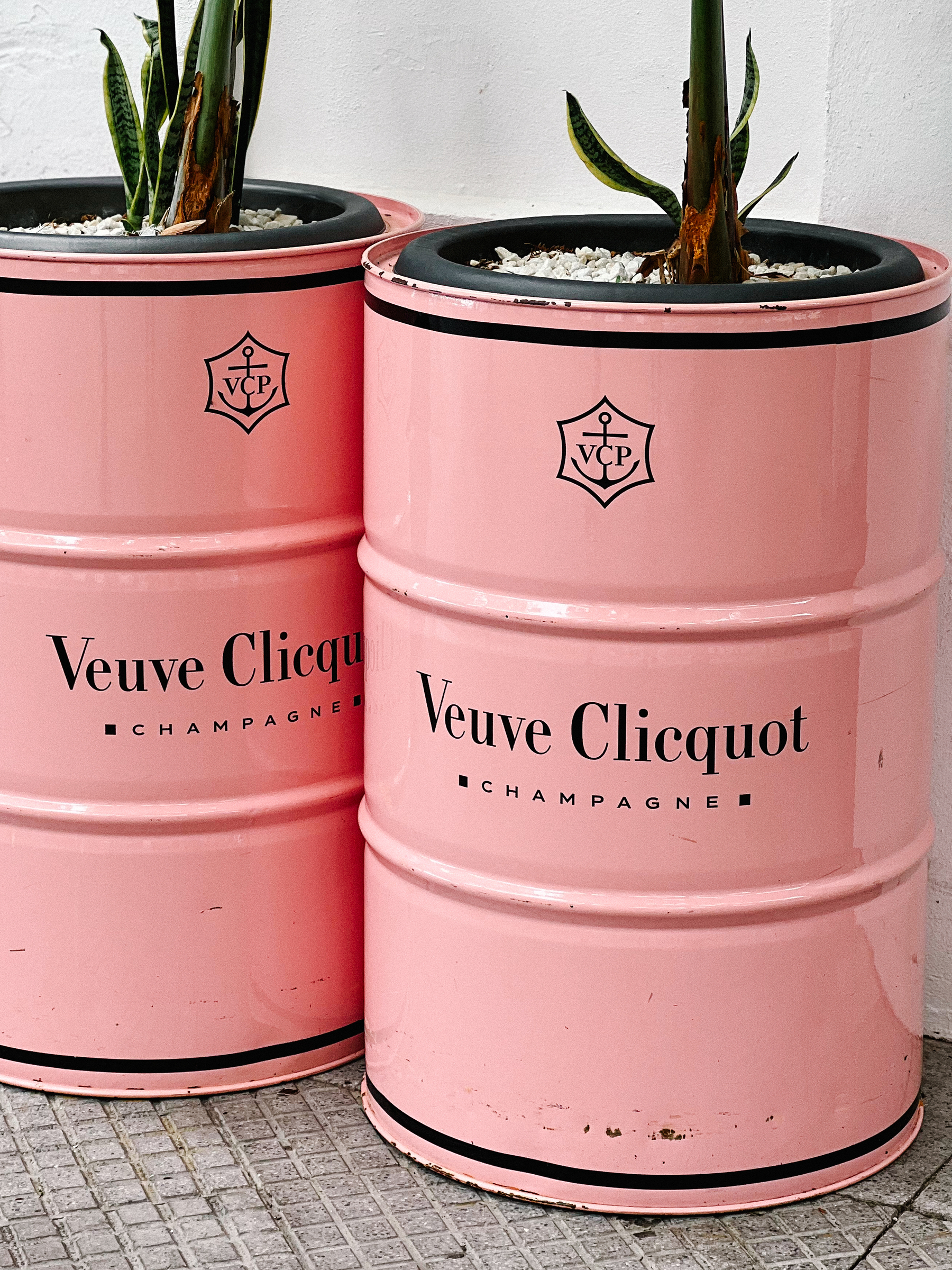 Two pink barrels with Veuve Clicquot written on them.