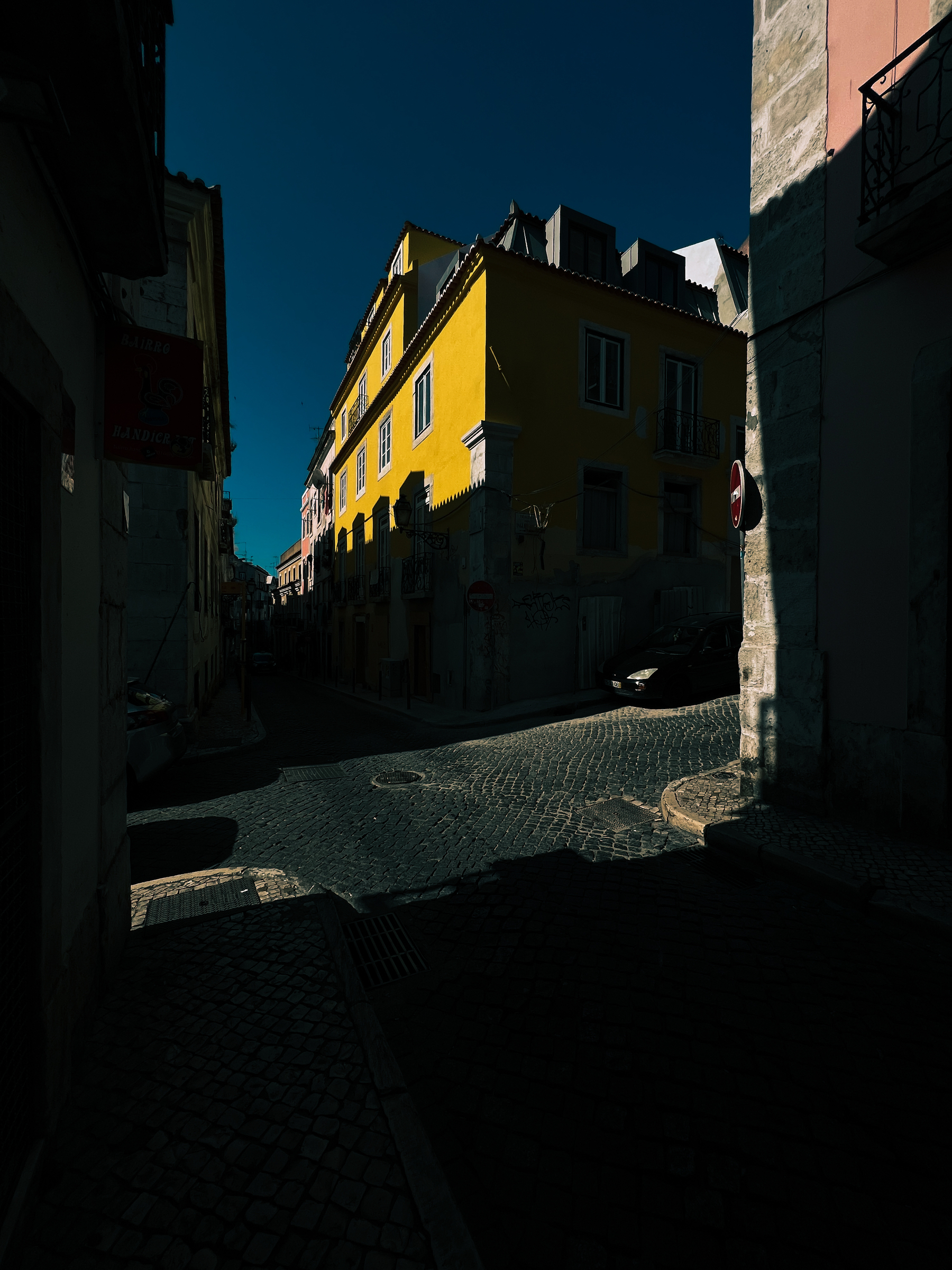 street corner with freshly painter yellow building.