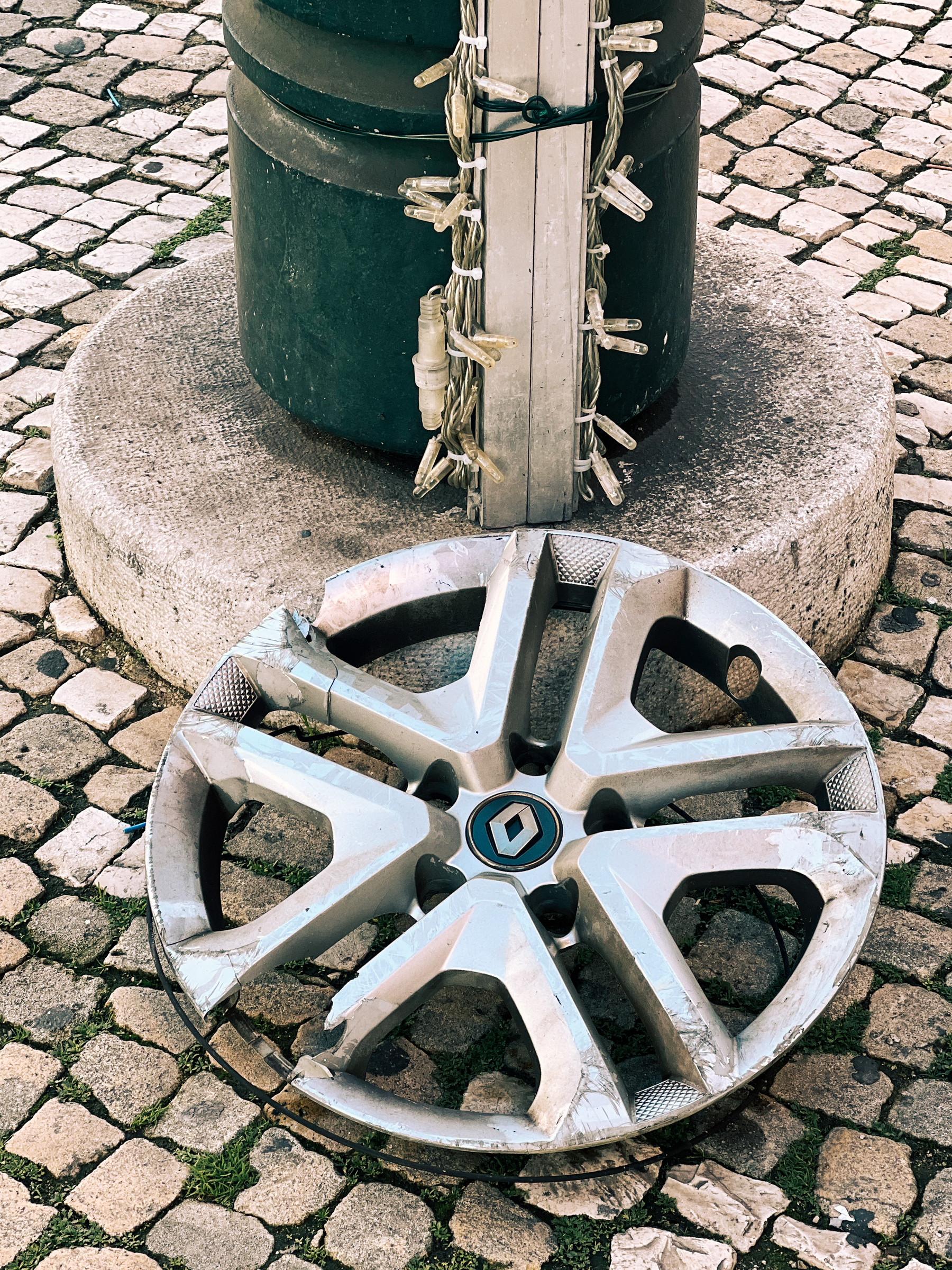 A wheel rim abandoned on the ground.