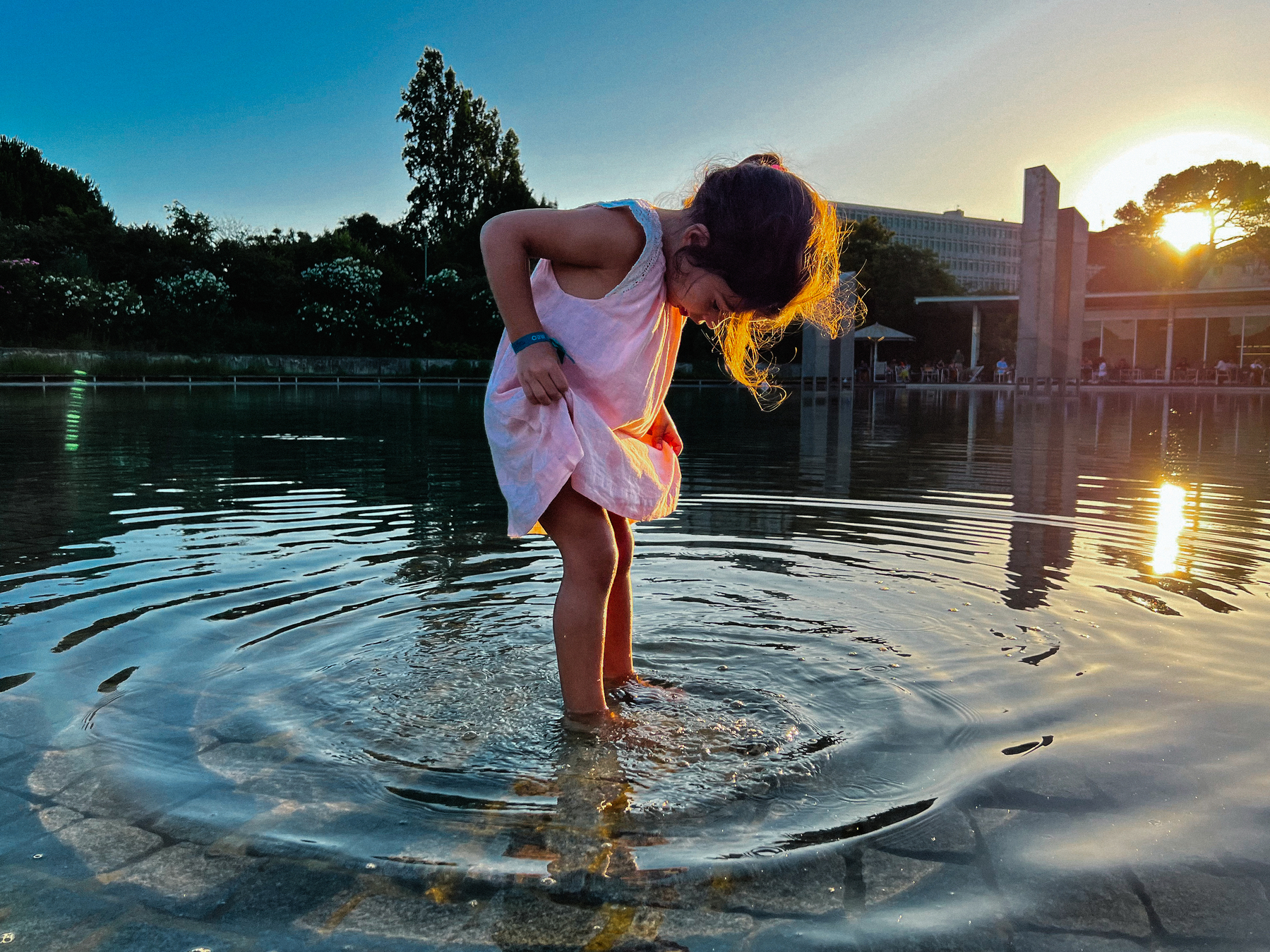 A girl having fun in a big pond. 