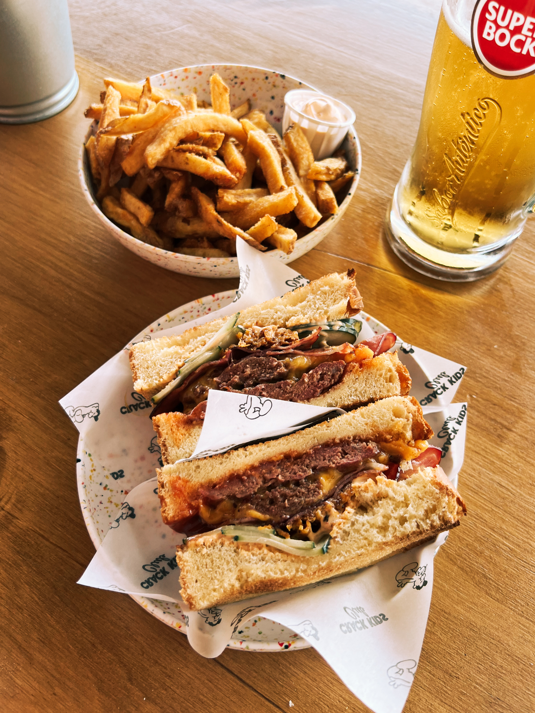 A cheeseburger sando, with fries and beer. 