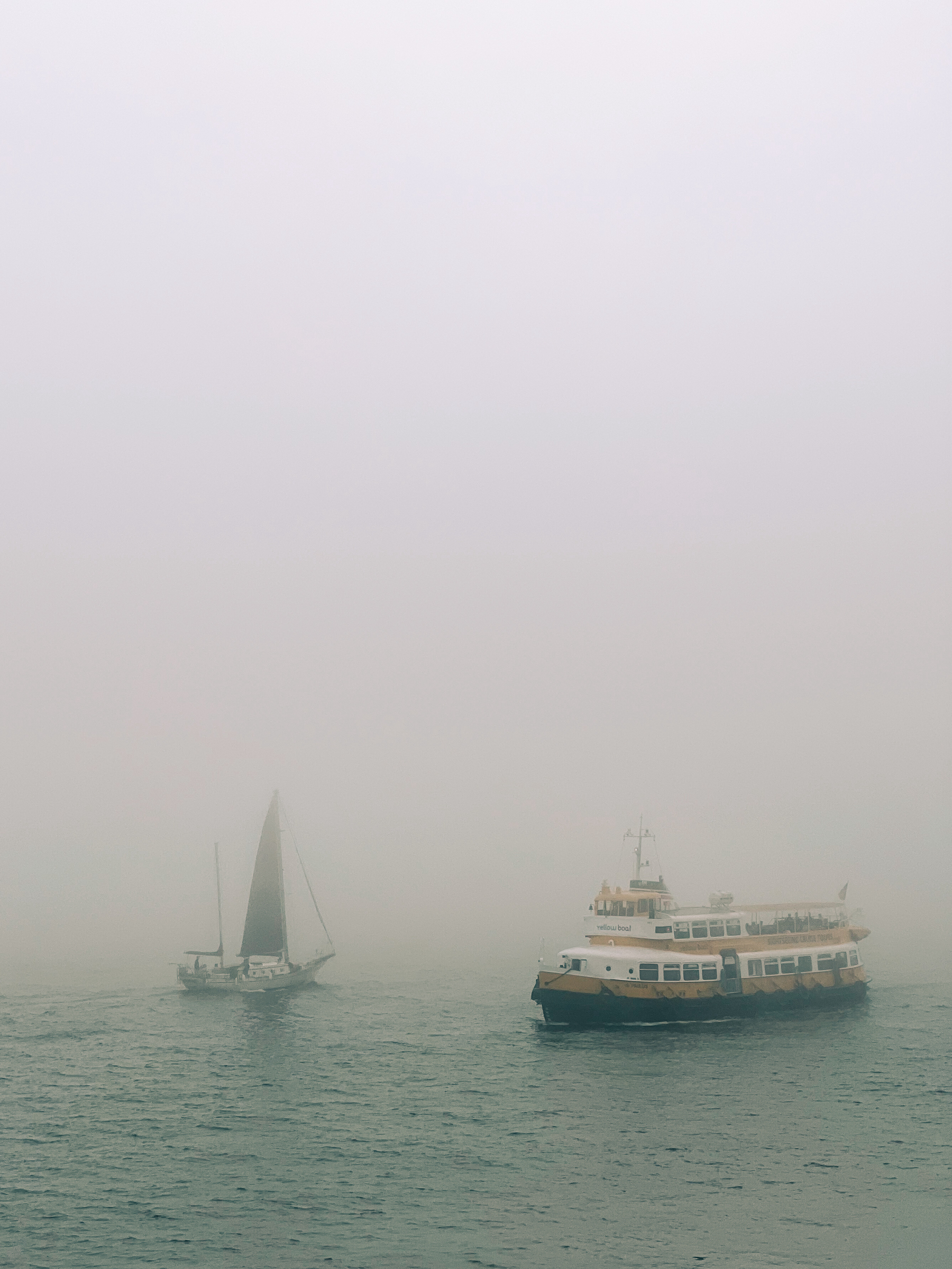 A boat and a ferry. Foggy. 