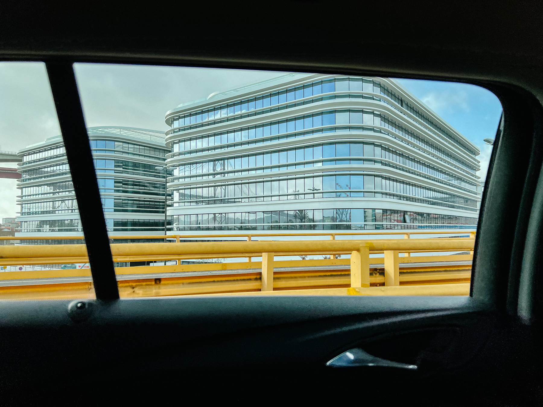 Glass buildings seen through the window of a car. 