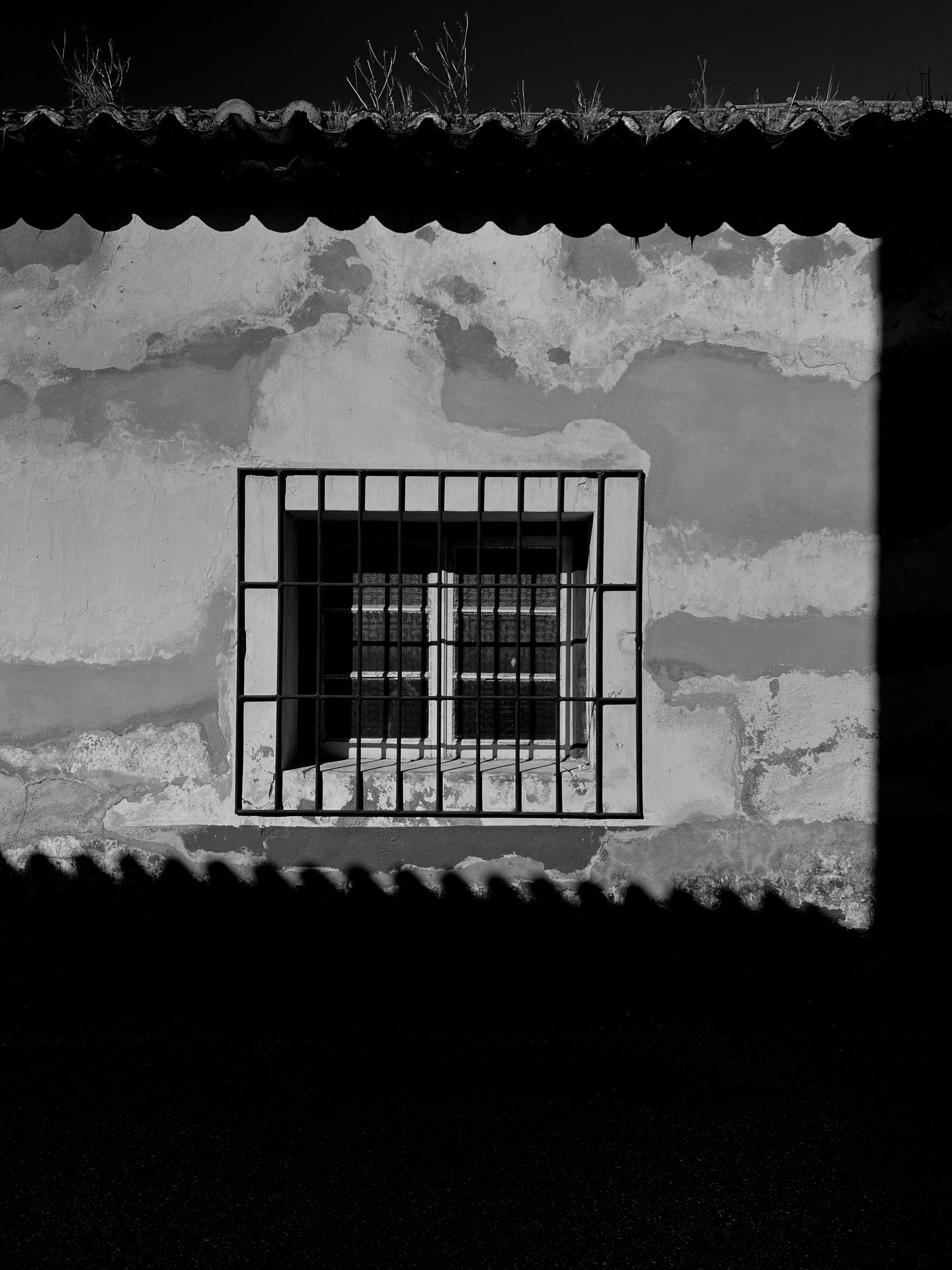 Black and white photo, a window. 