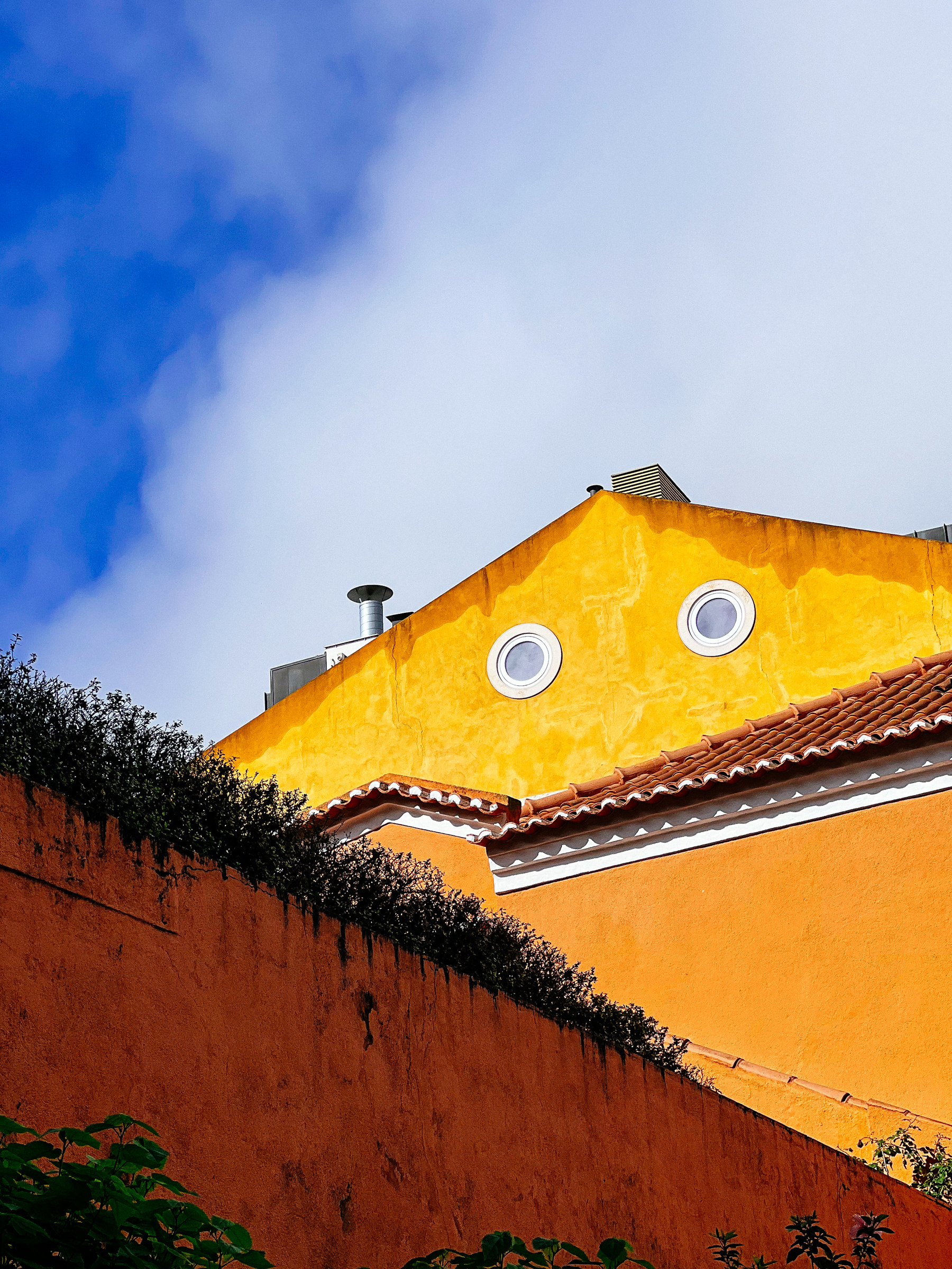 Eyes on the side of a yellow house. 