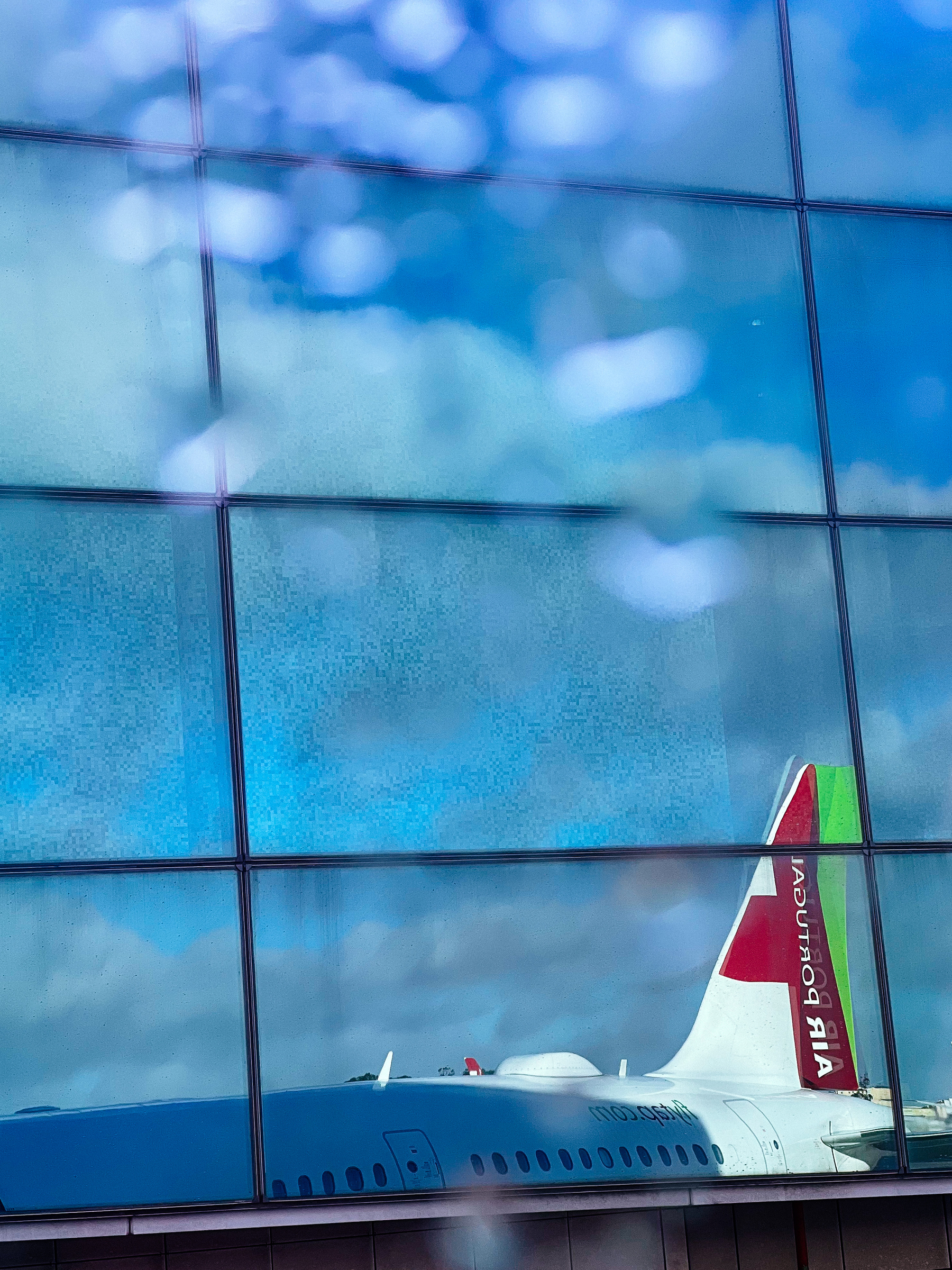 An airplane reflection, in a window 