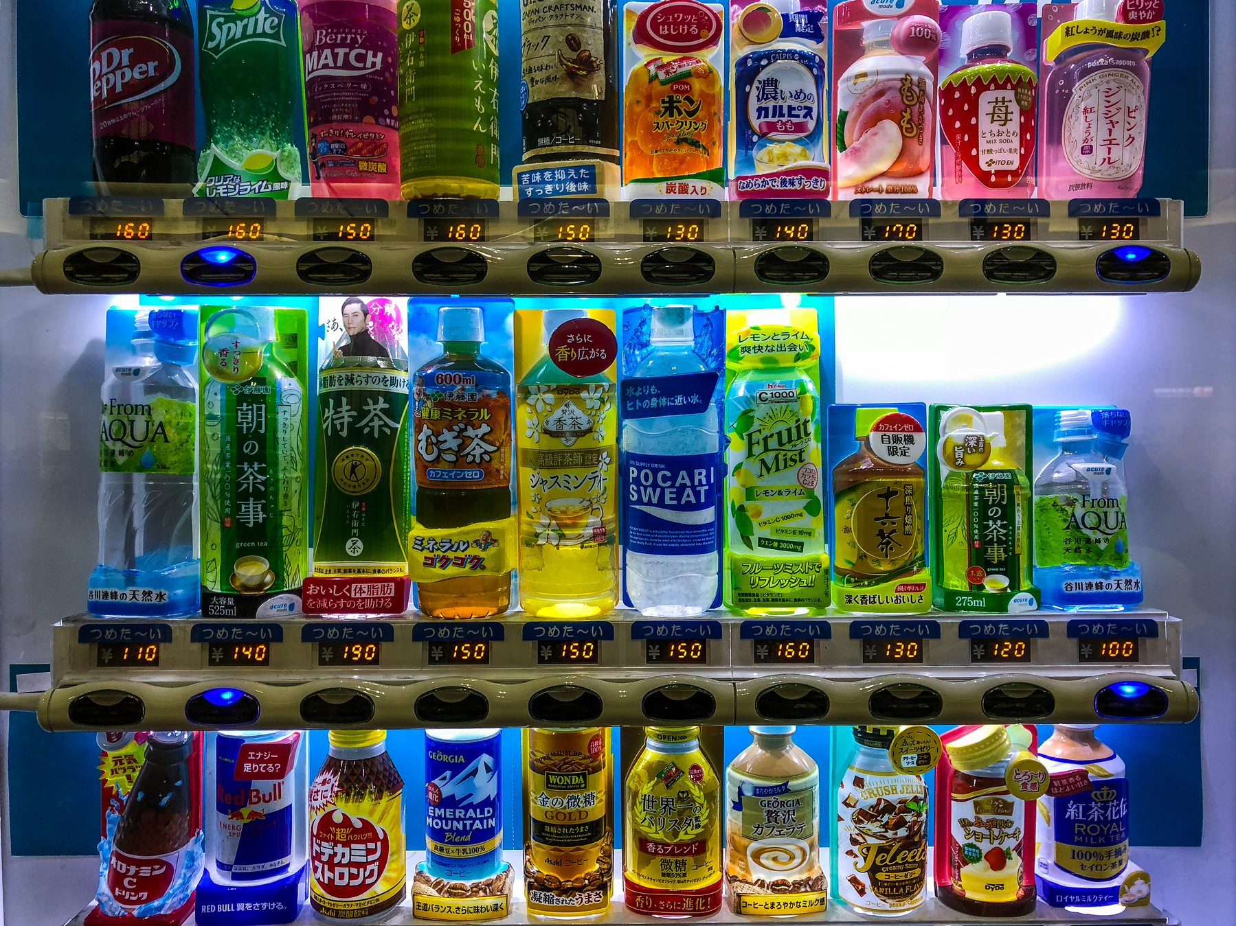 An assortment of colorful drinks on a vending machine.