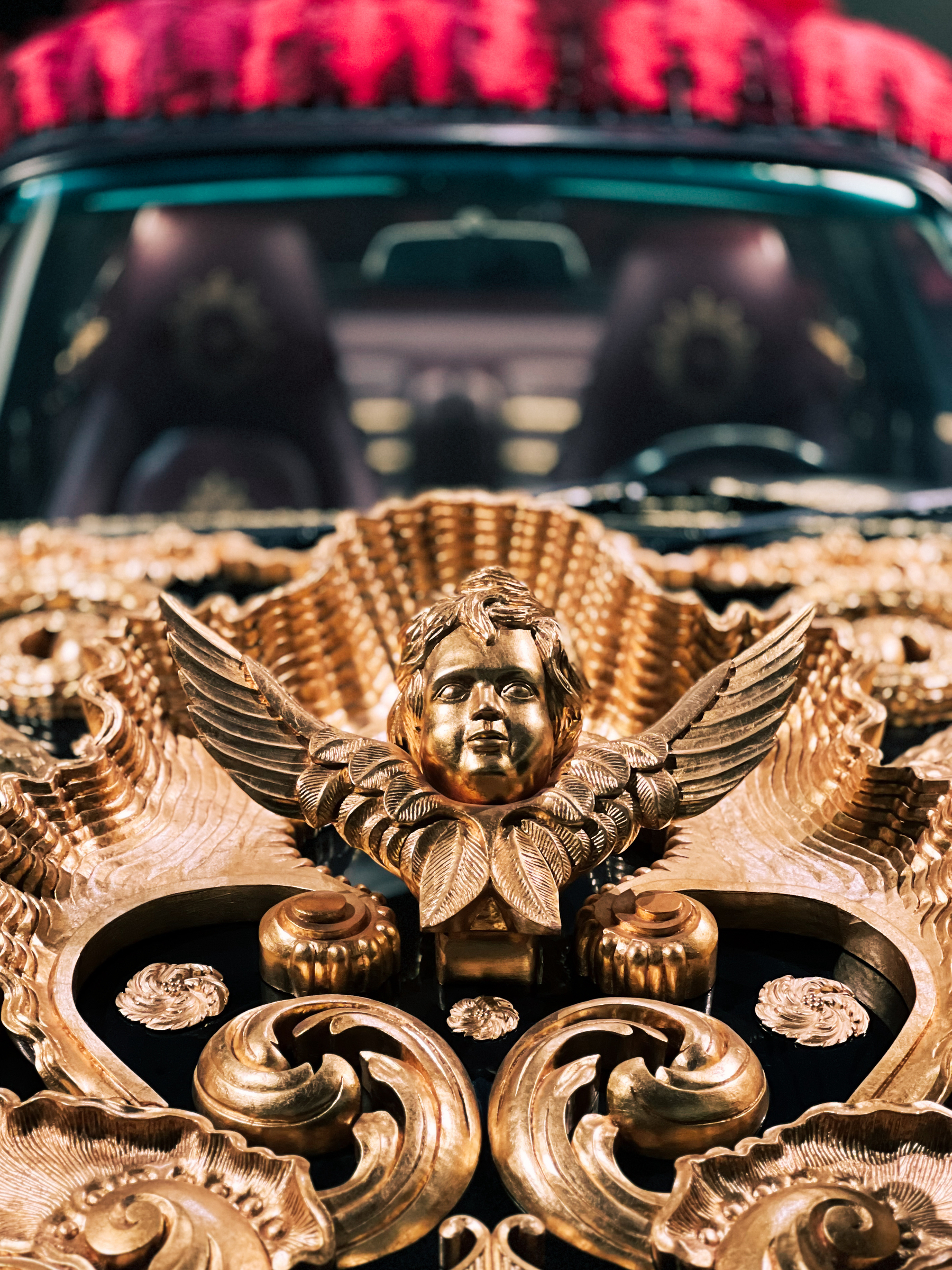 Detail of a Porsche, a golden angel on the hood. Art work by Joana Vasconcelos. 