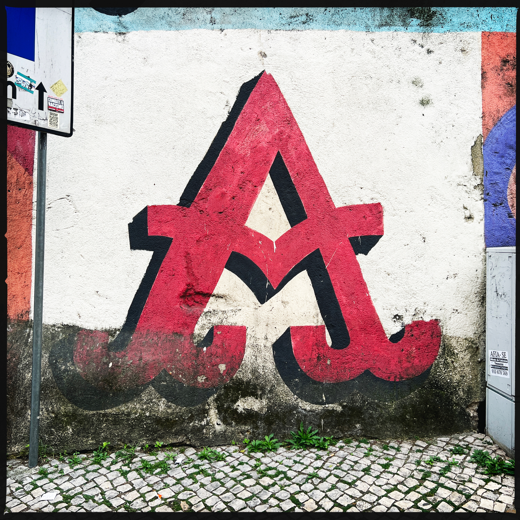 The letter A graffitied onto a wall