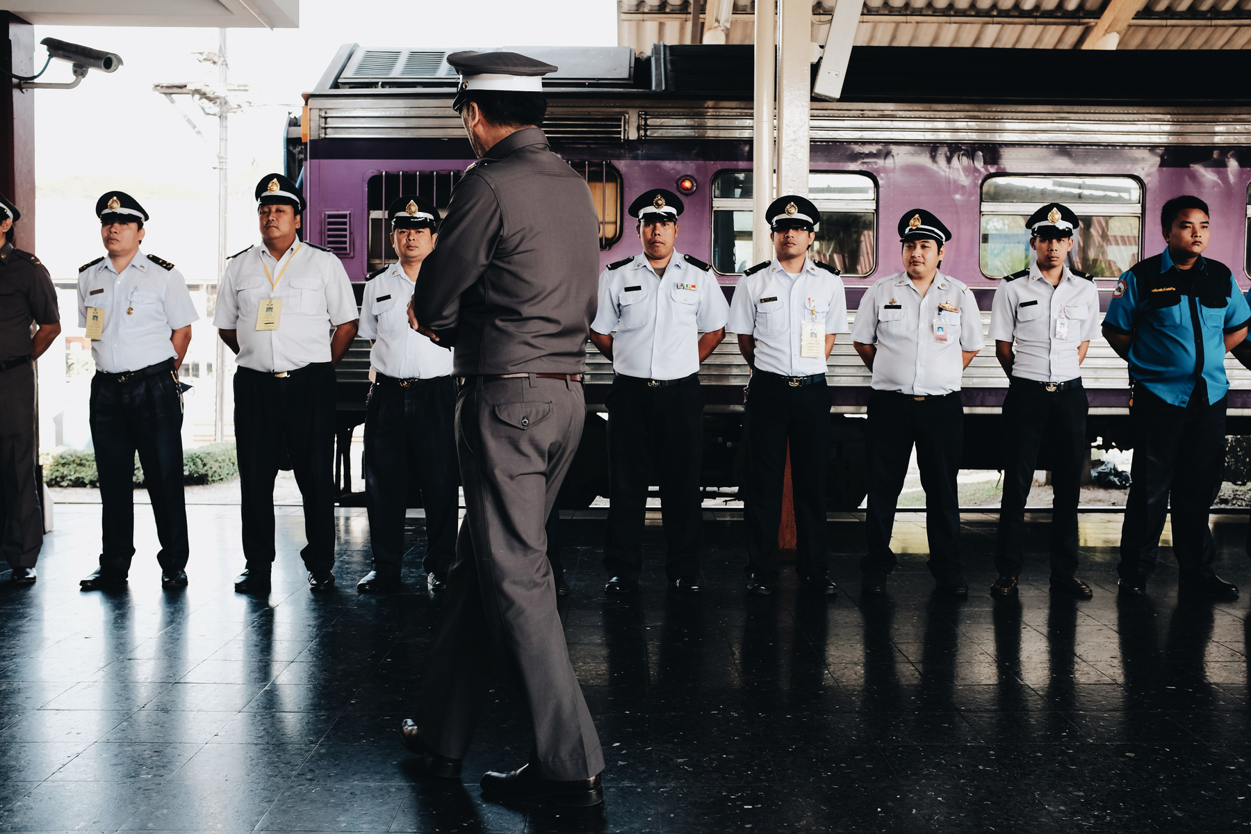 A train conductor talks with the crew before departing.