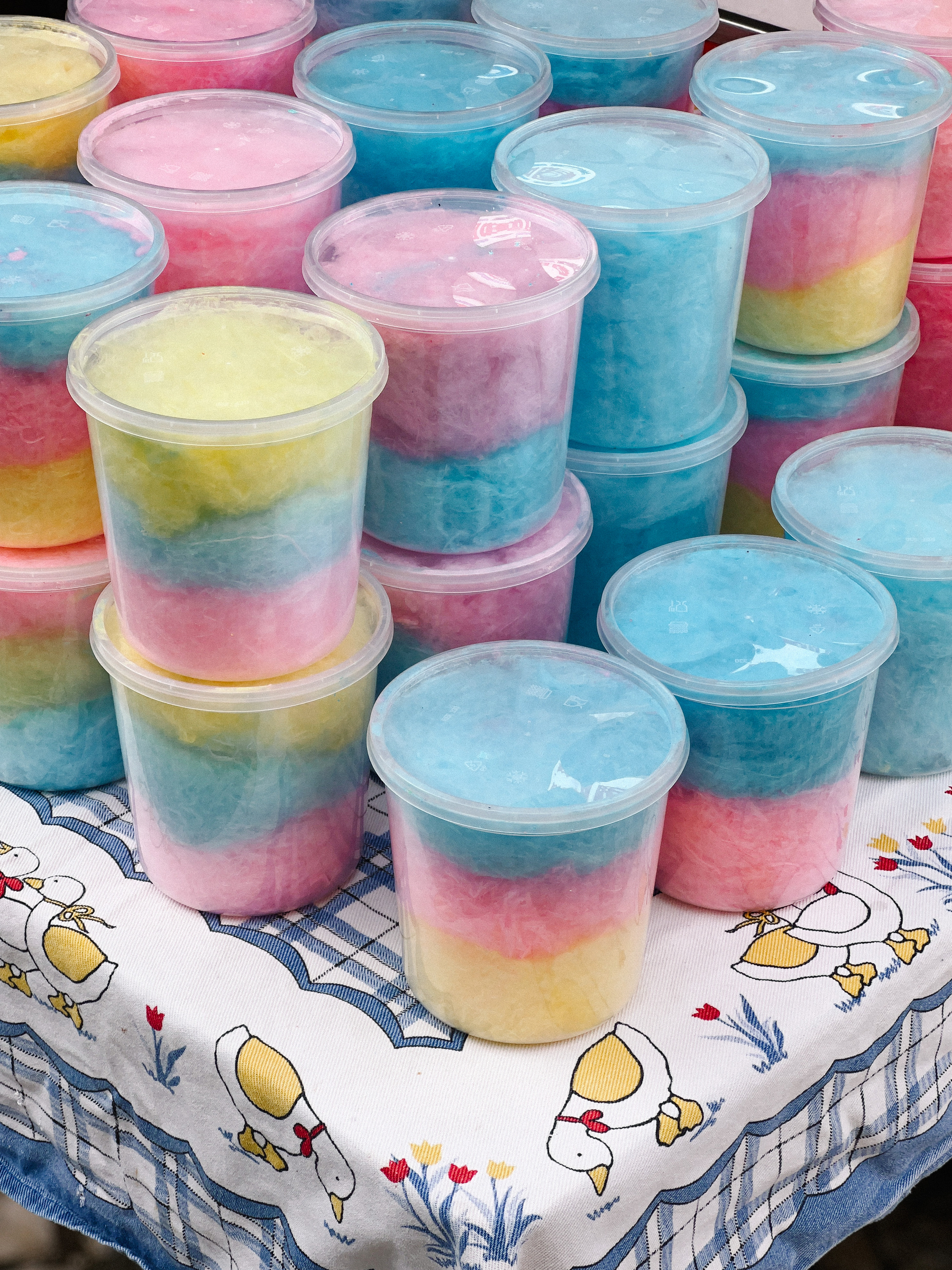 Plastic buckets filled with colorful cotton candy. 