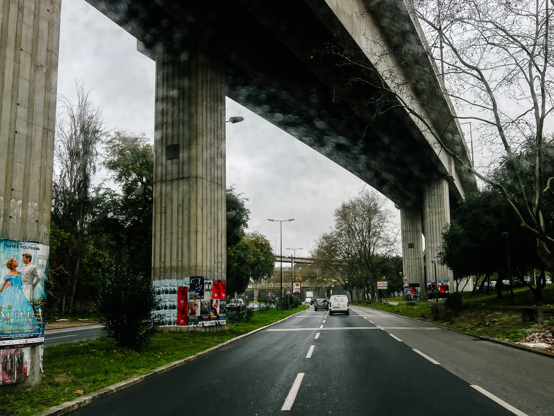 driving under a big concrete bridge