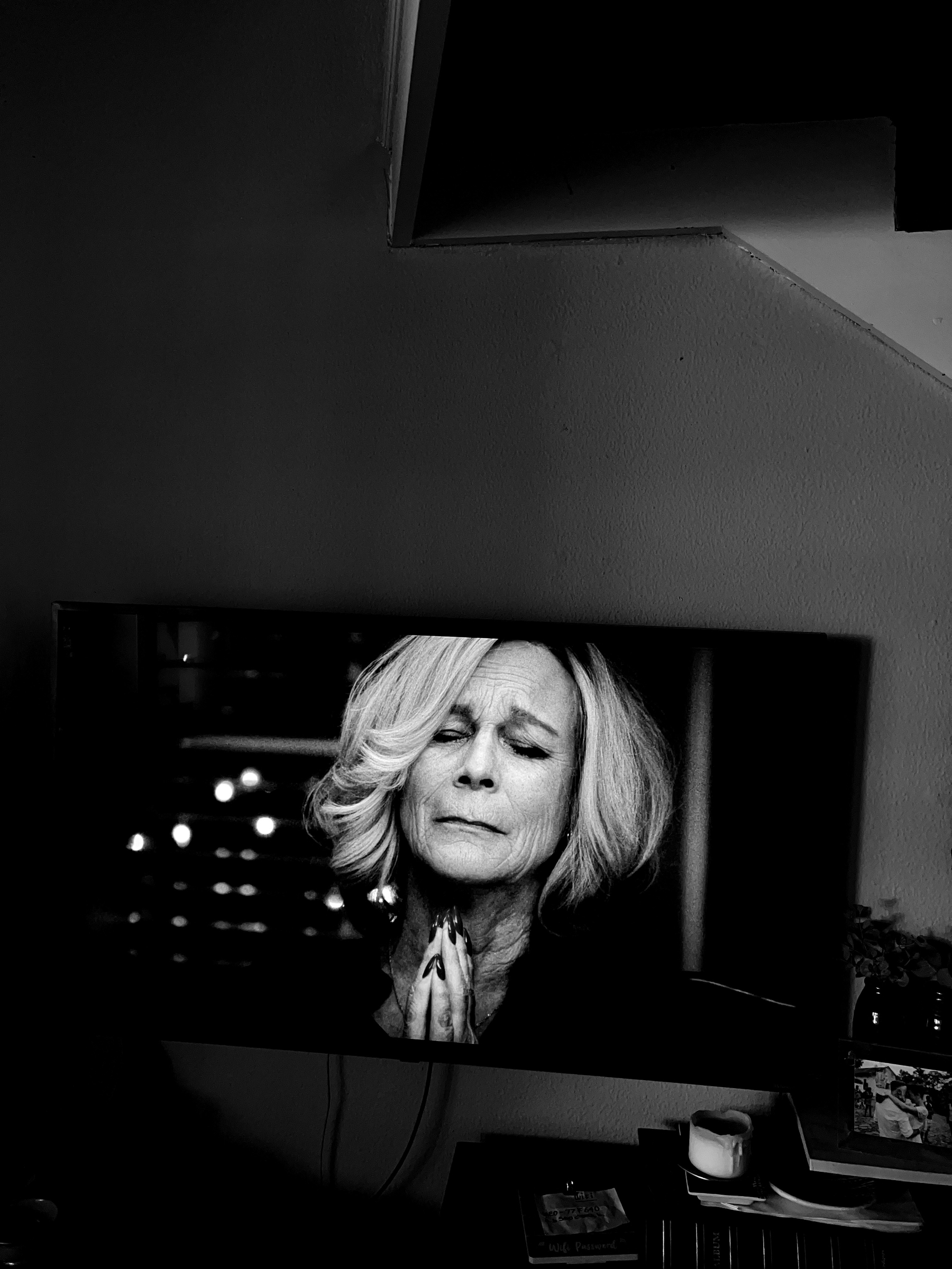 Black and white photo of Jamie Lee Curtis on a tv. 