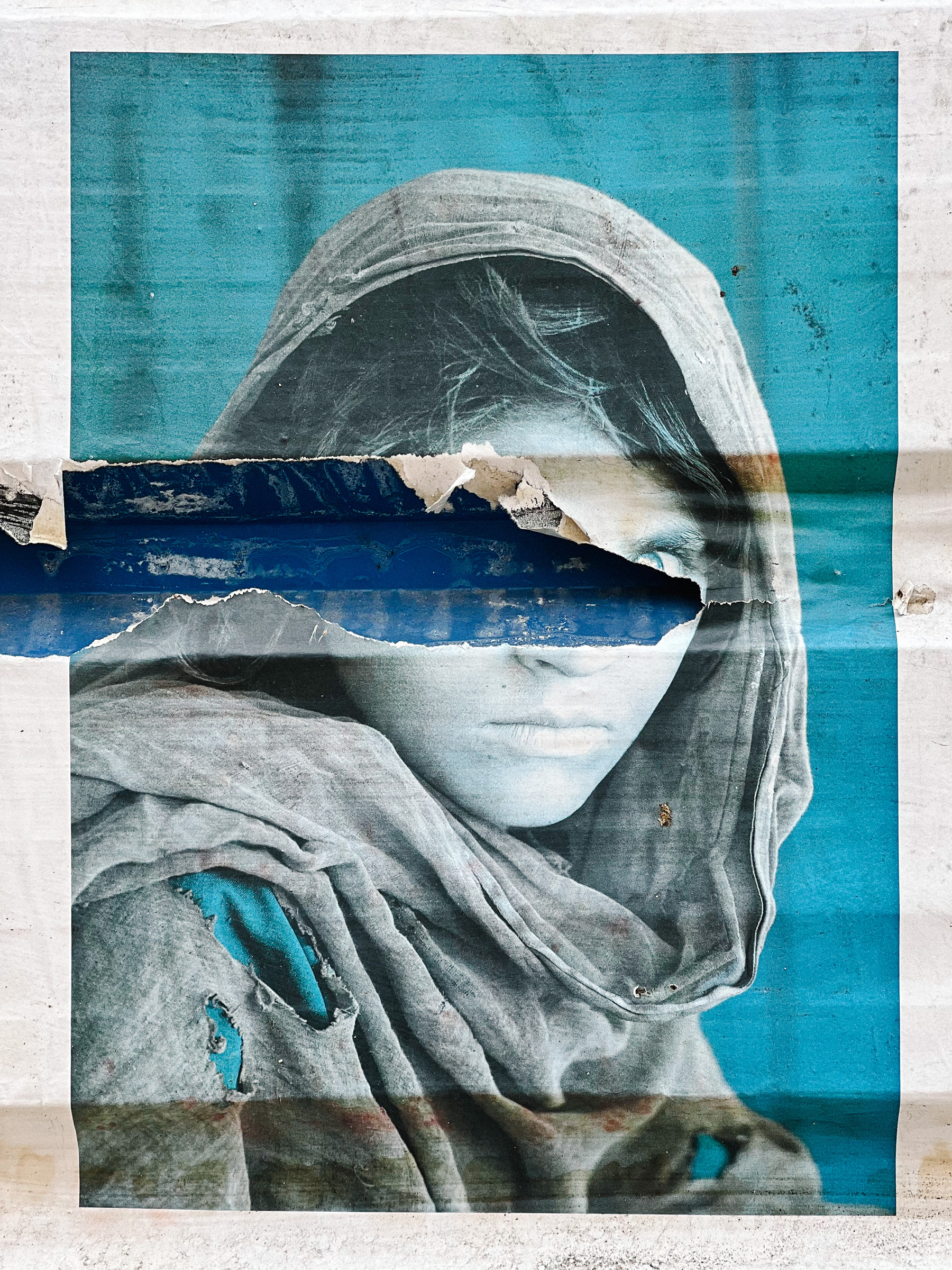 Steve McCurry’s famous Afghan girl portrait, faded, and partially destroyed. 
