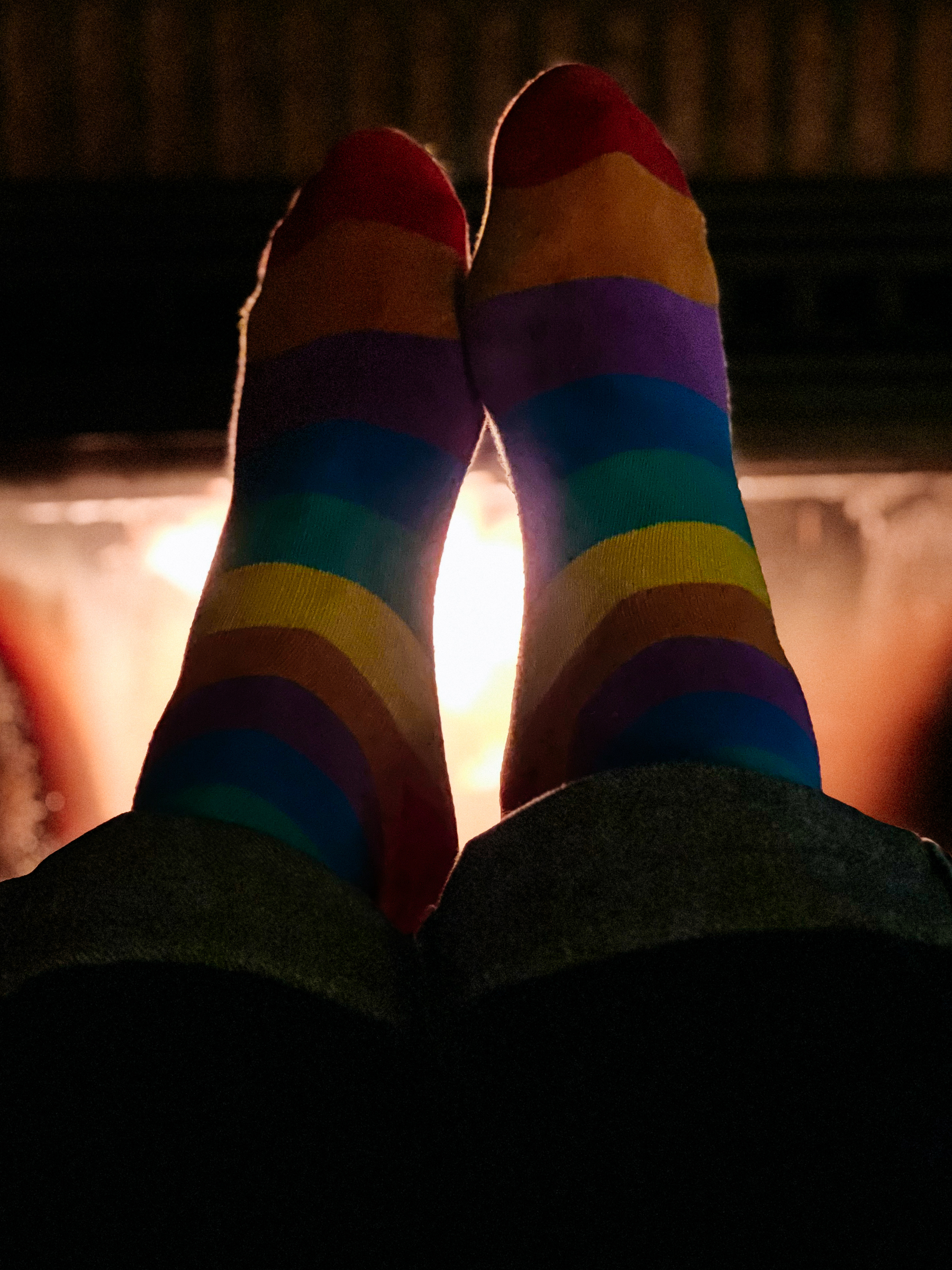 Rainbow socks by the fireplace.