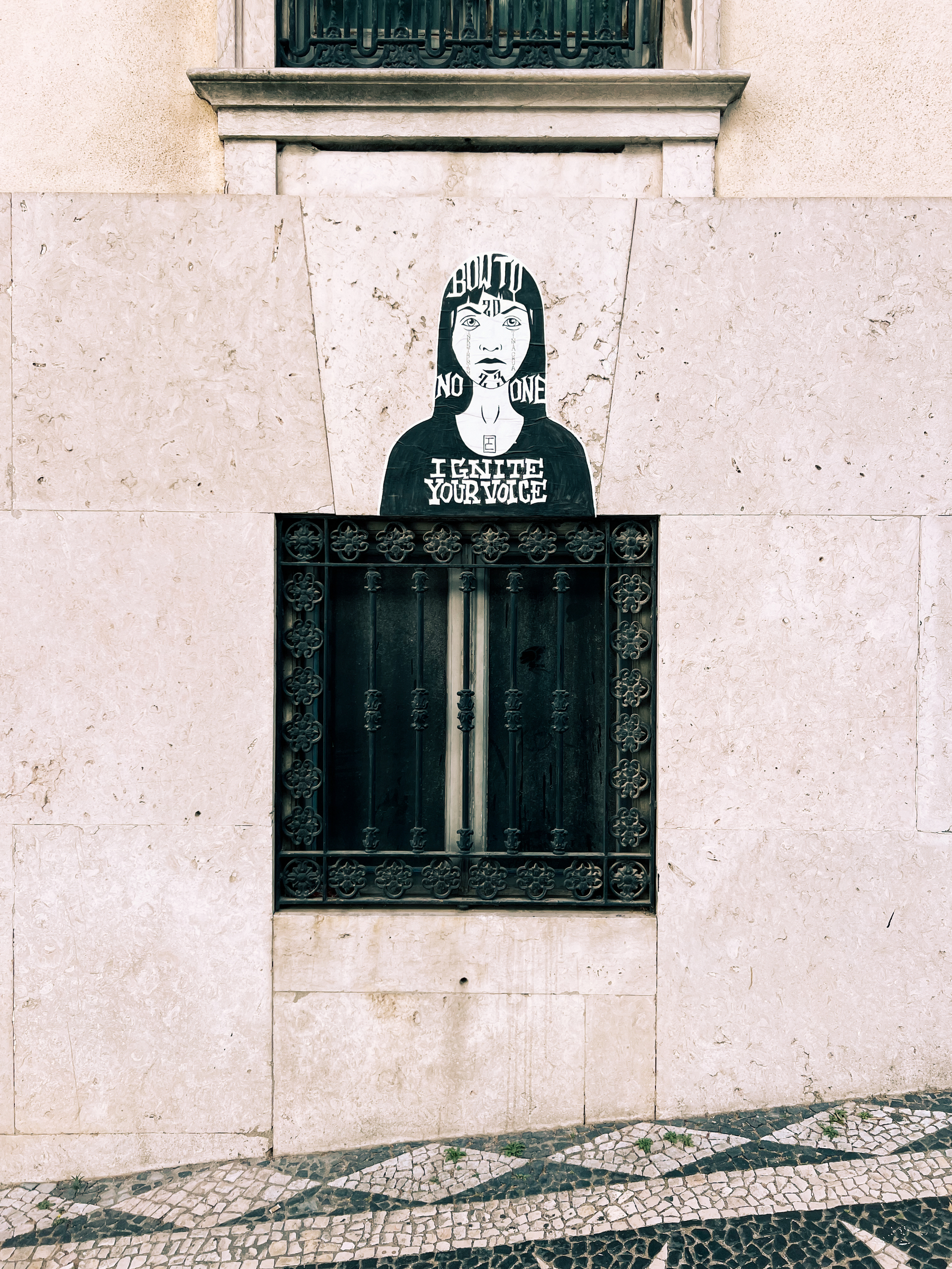 A big sticker with an image of a girl, over a window.