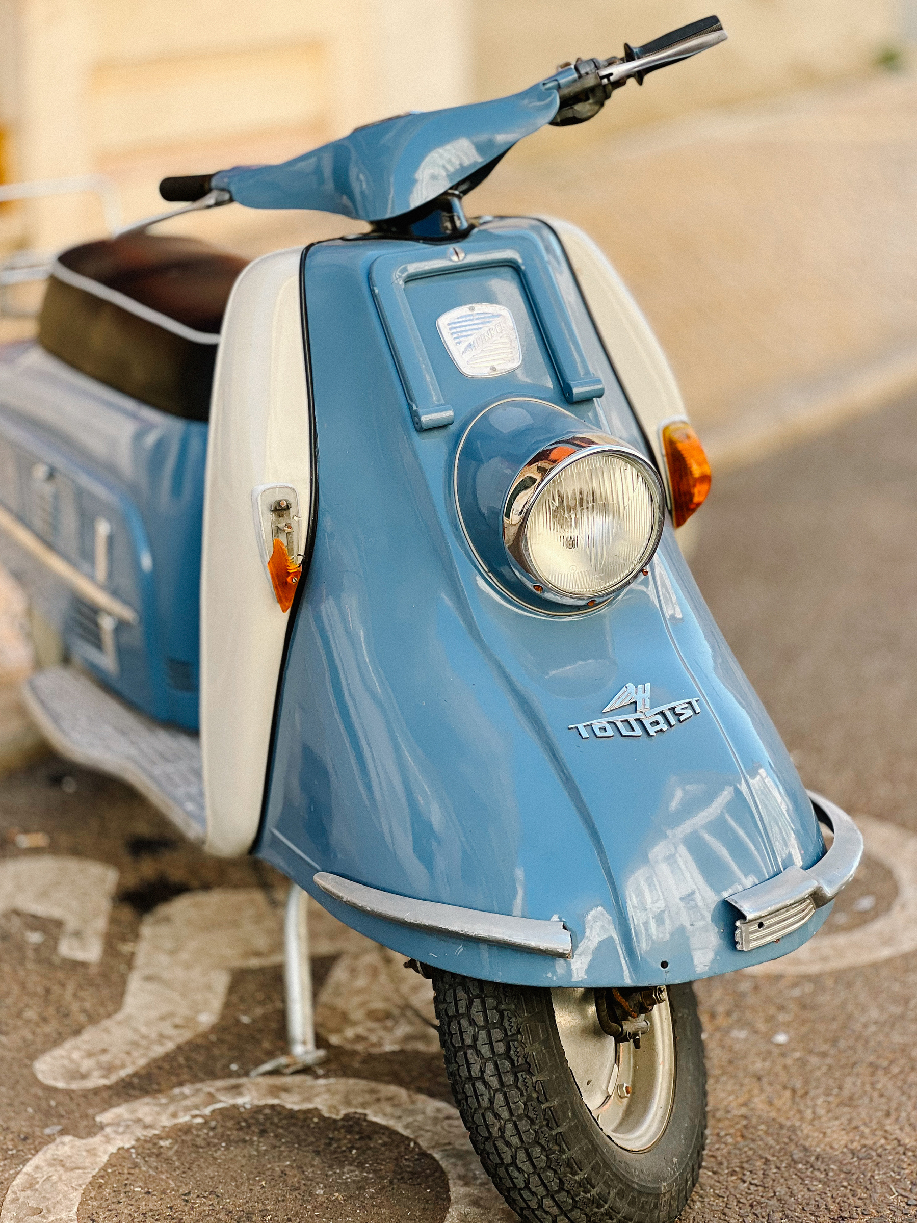 A baby blue vintage scooter. 