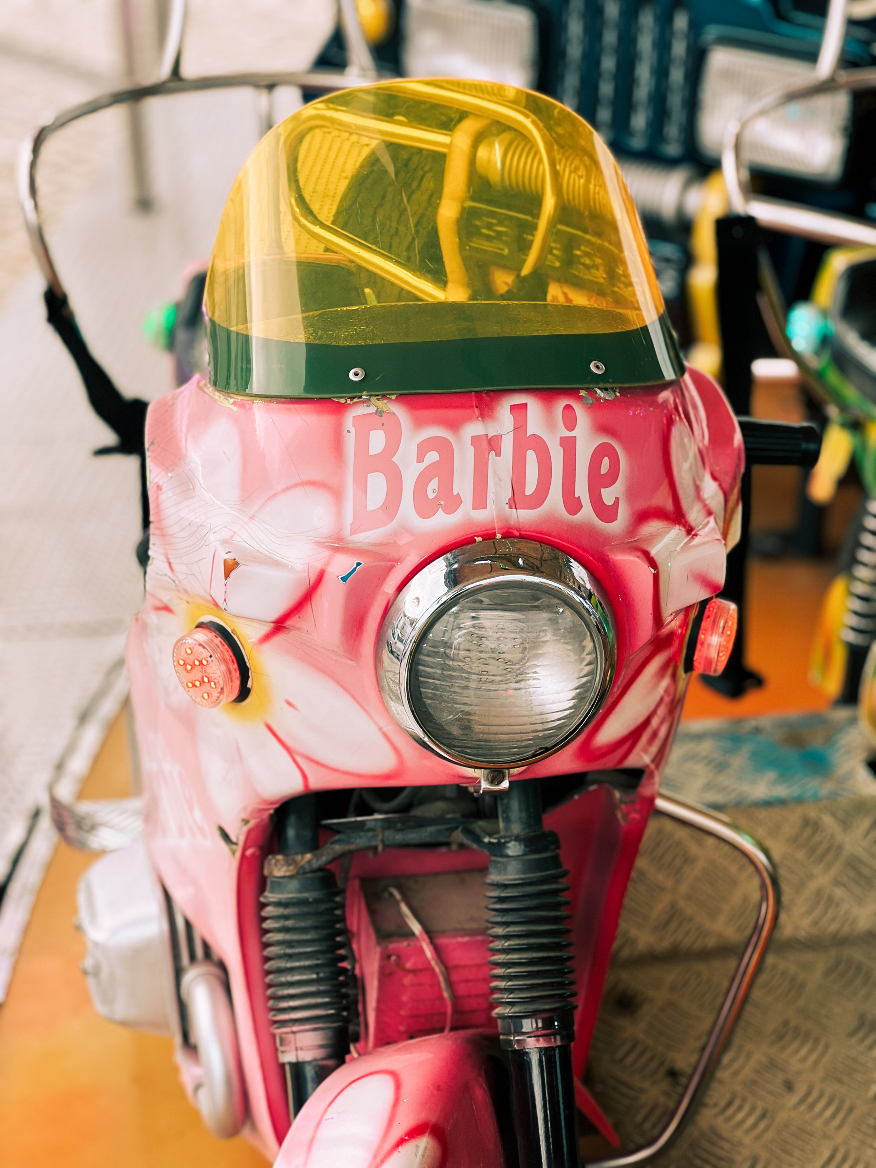 A toy motorcycle with a Barbie paint job. 