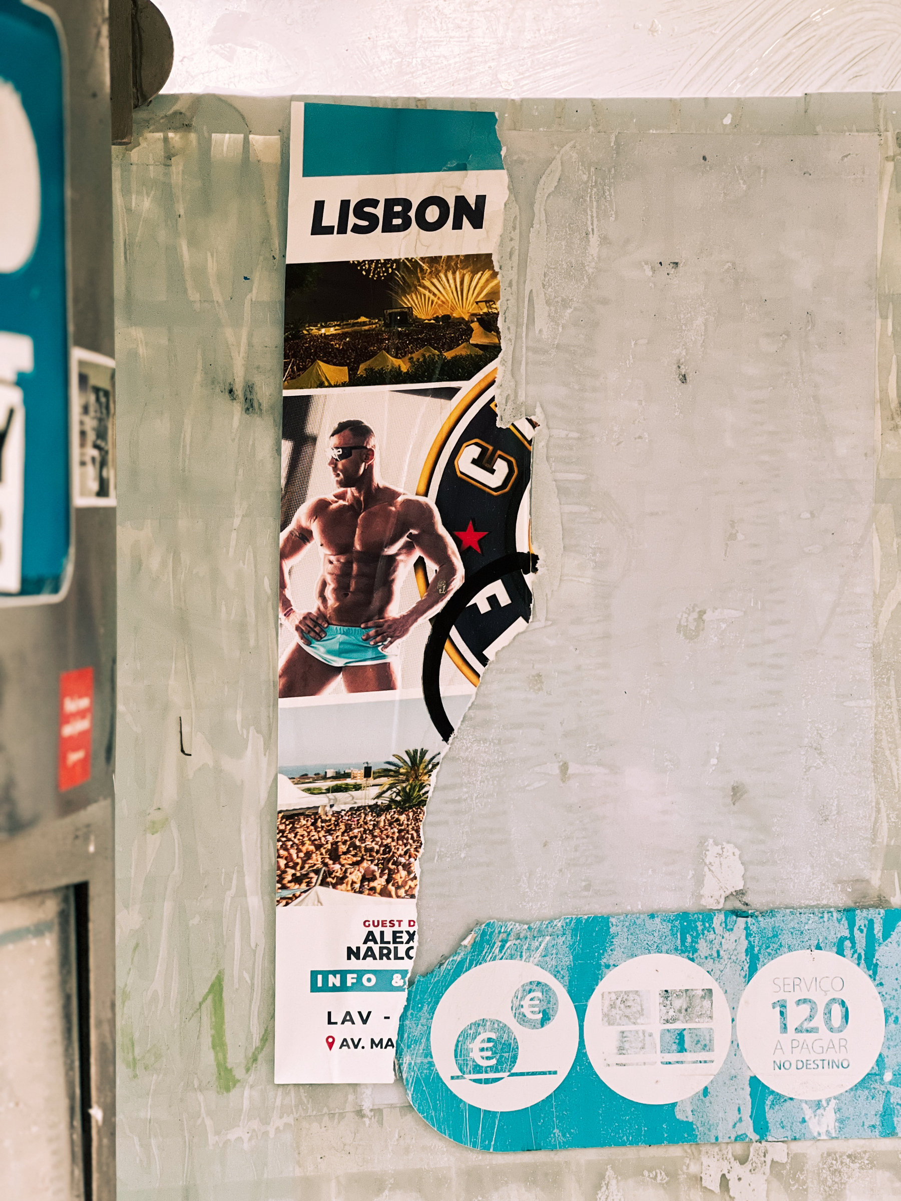 A muscular gentleman, and the word “Lisbon” above him. It’s a poster, most of it is missing. 