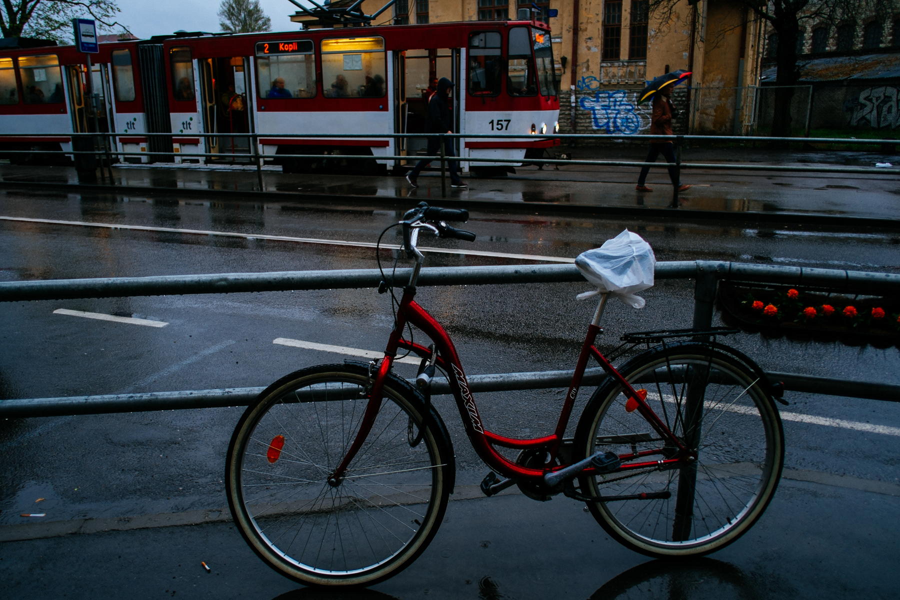 A red bicycle on a rainy day.