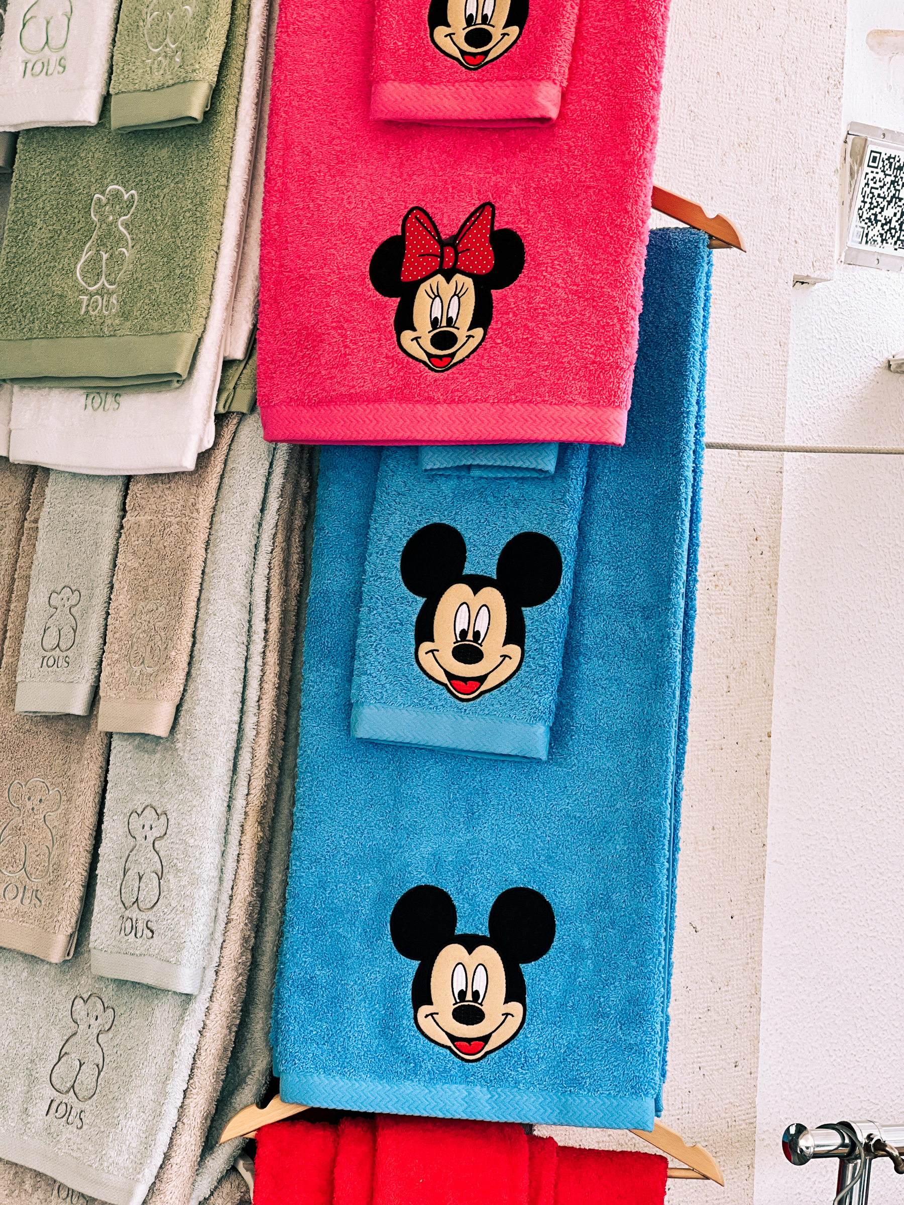 Towels on display, Mickey and Minnie embroidered on them. 