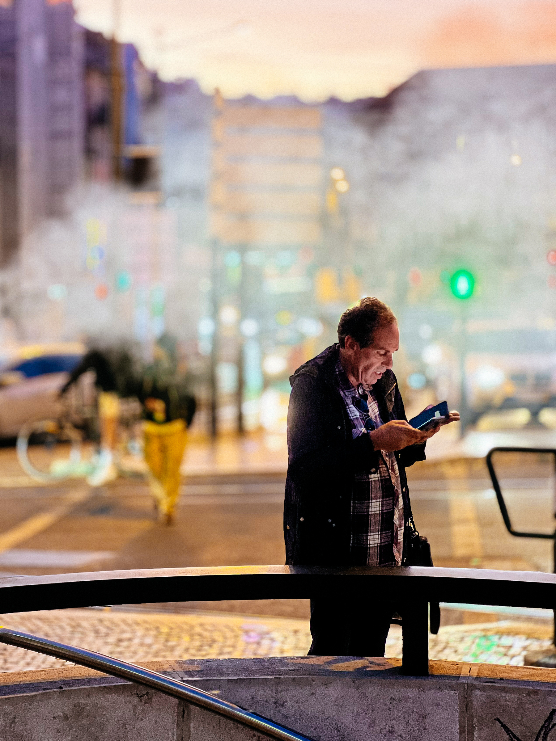 A man uses his cellphone. Smoke in the air. 