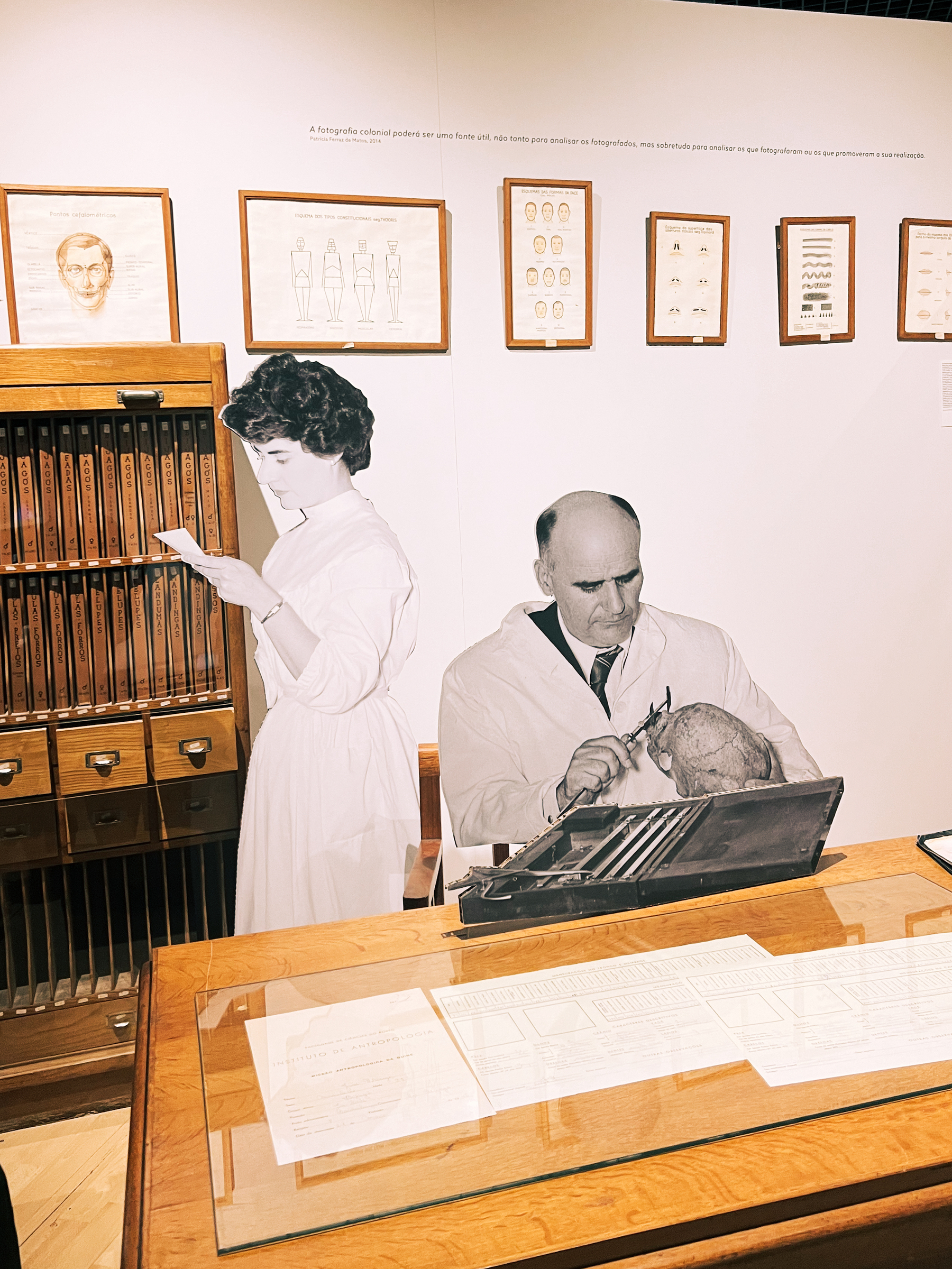 An exhibition with life sized black and white figures, a doctor and a nurse. 