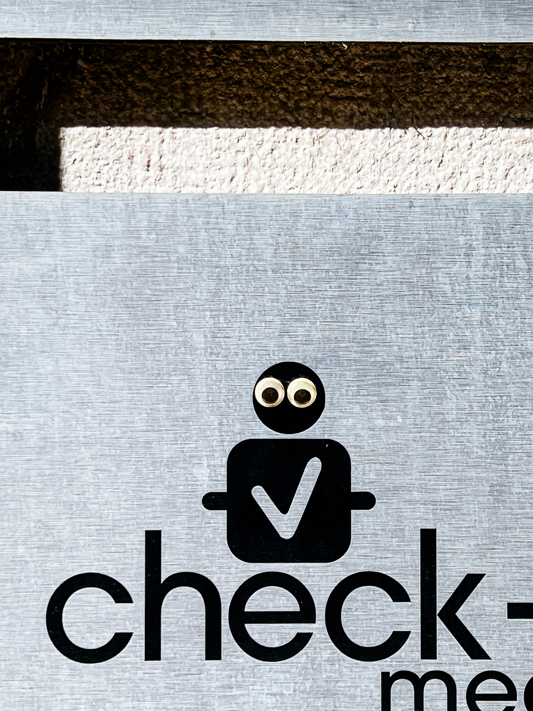 A plaque for medical check ups, where googly eyes have been added. 